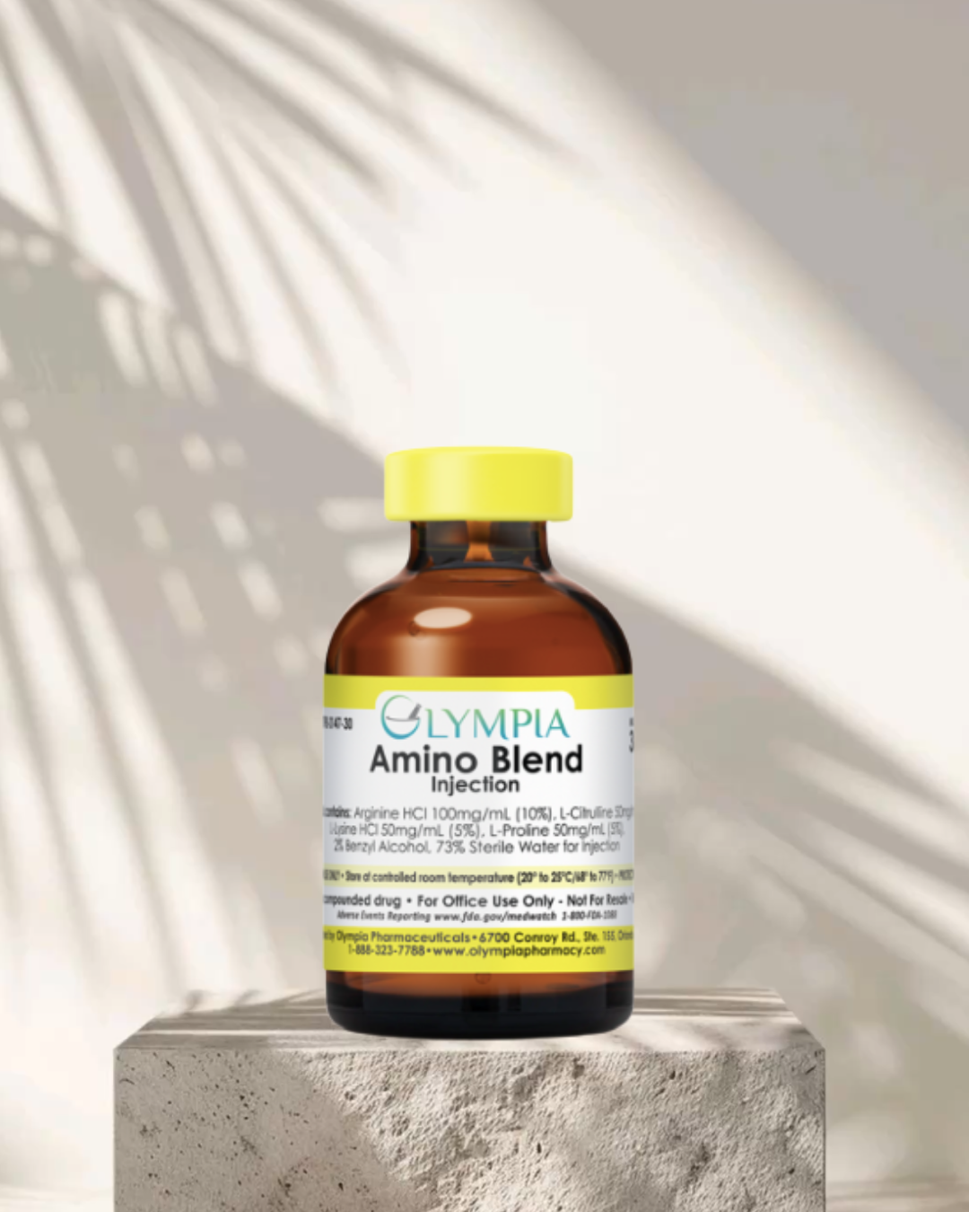 A brown medicine bottle with a yellow cap labeled 'Olympia Amino Blend Injection'. The label lists ingredients and usage directions, and the bottle is placed on a concrete block with bright sunlight and shadow patterns on the wall behind.