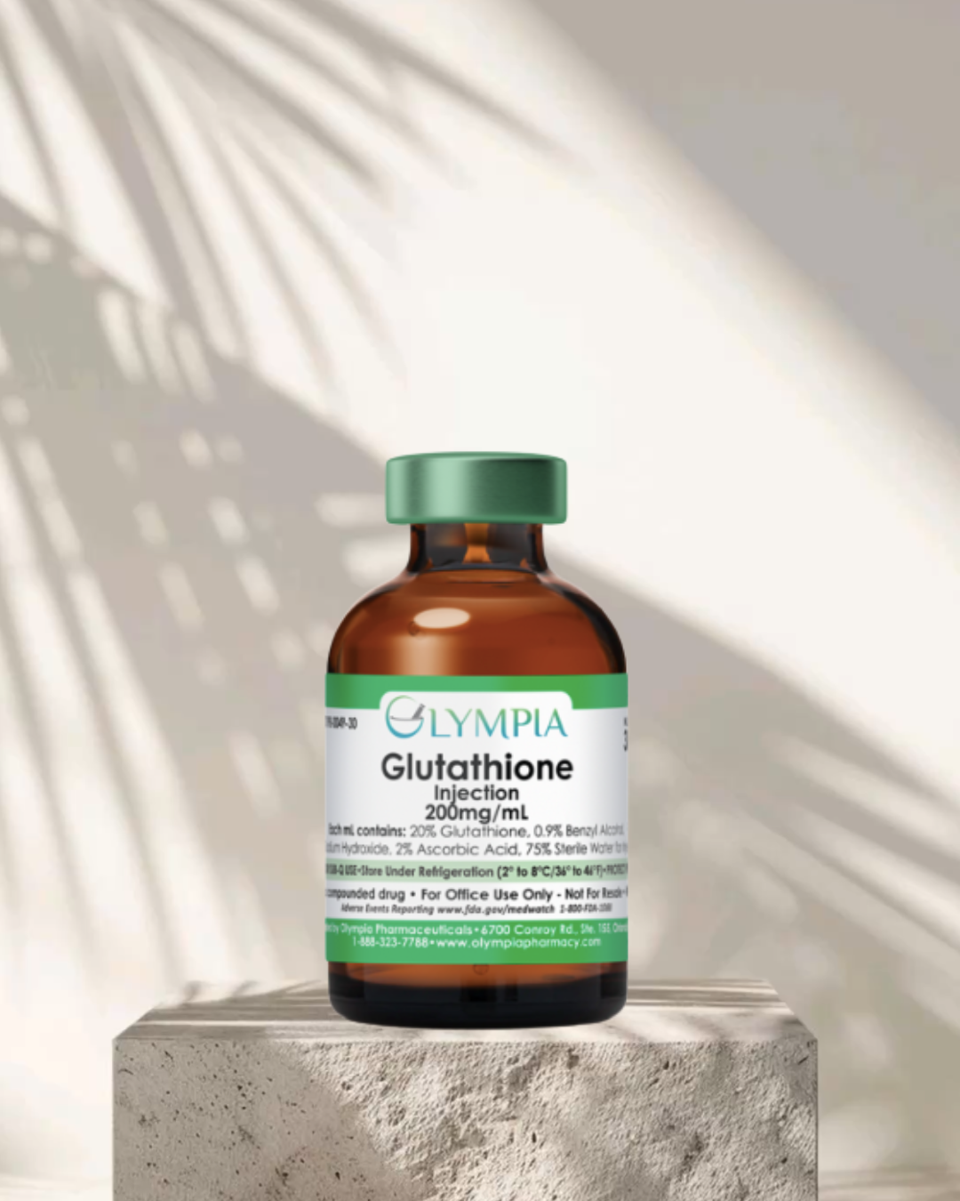 A brown glass vial labeled 'Glympia Glutathione Injection 200mg/mL' with a green cap, placed on a concrete pedestal, with light and shadow patterns on a white background.