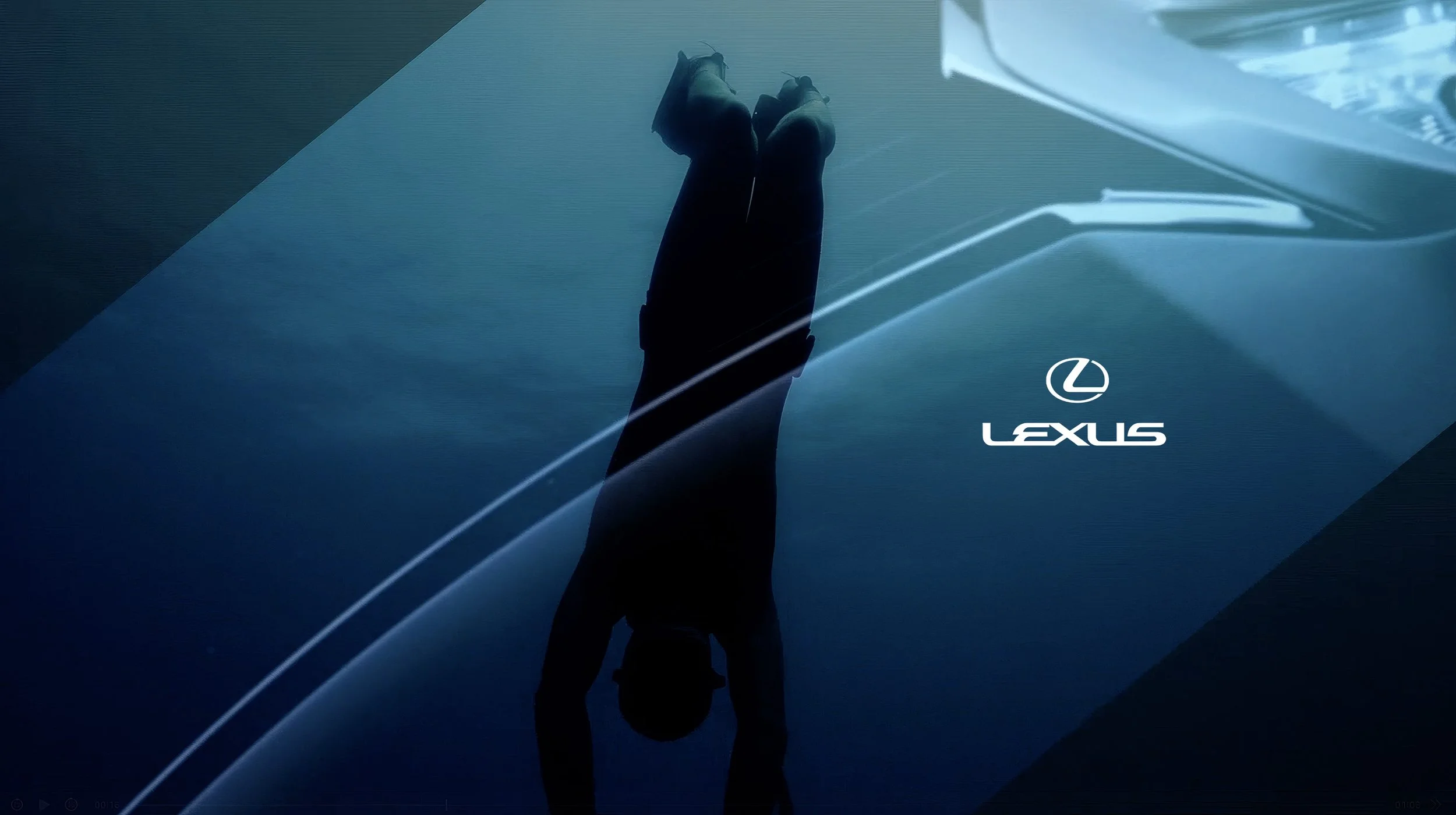 An individual bending forward with hands on the ground, seen reflected in a glossy surface, with the Lexus logo and branding in the foreground.