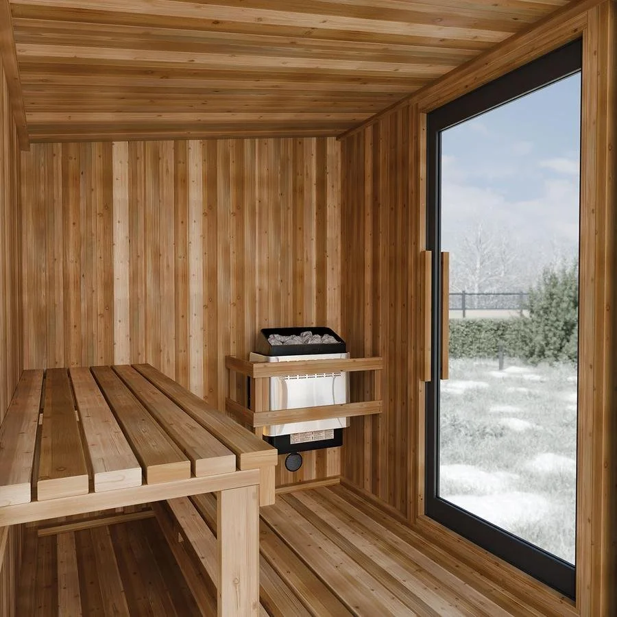 Interior of a wooden sauna with a bench, a heater, and a large glass door showing an outdoor winter scene.