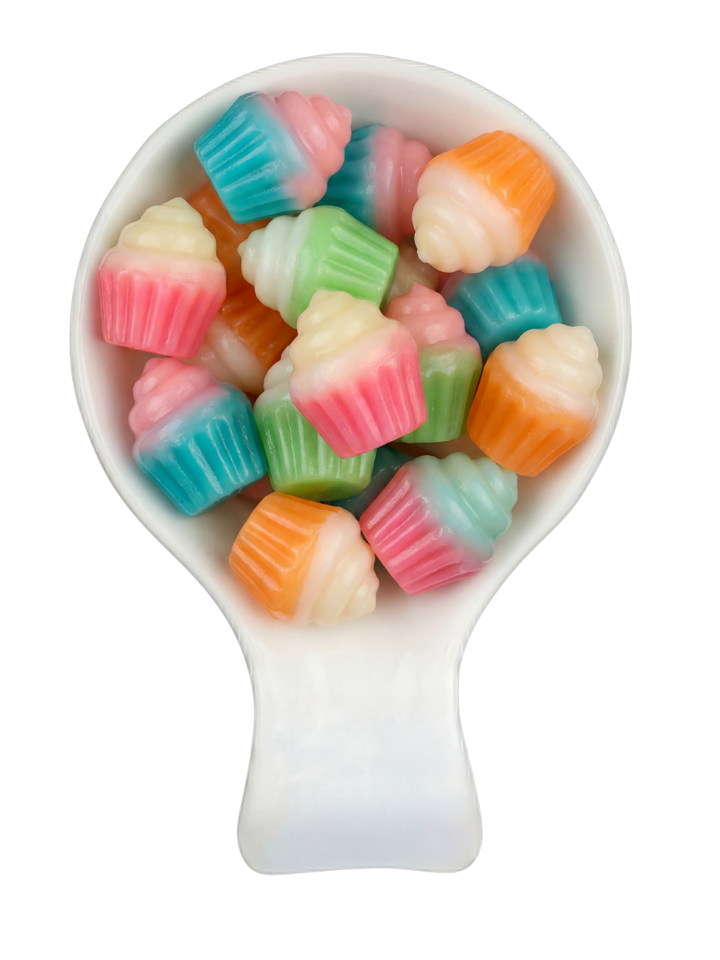 Colorful, miniature cupcake-shaped candies in a white spoon against a black background.