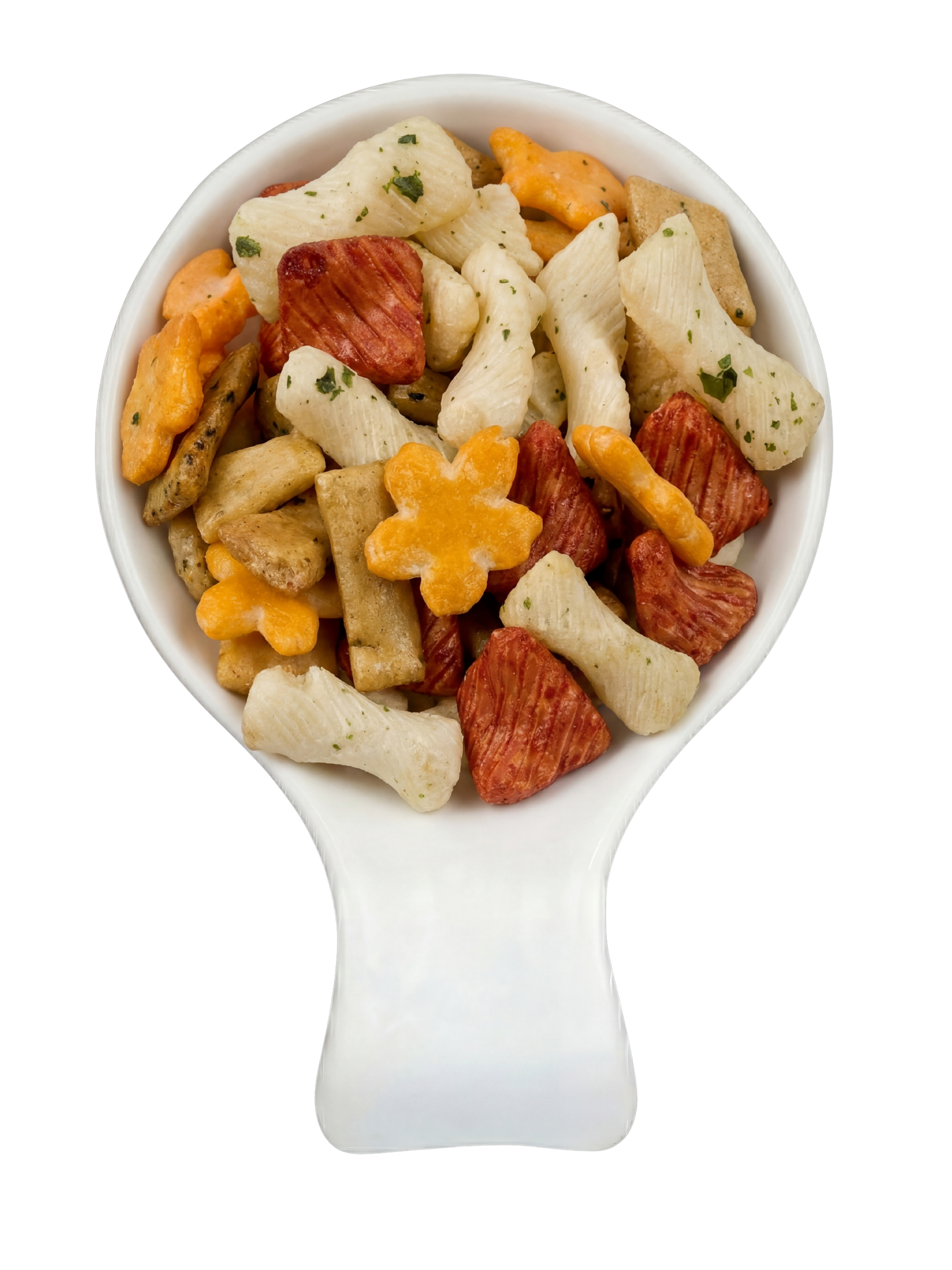 A white ceramic spoon filled with various snack crackers, including flower-shaped, rectangular, star-shaped, and irregular shapes, with some sprinkled with green herbs, set against a black background.