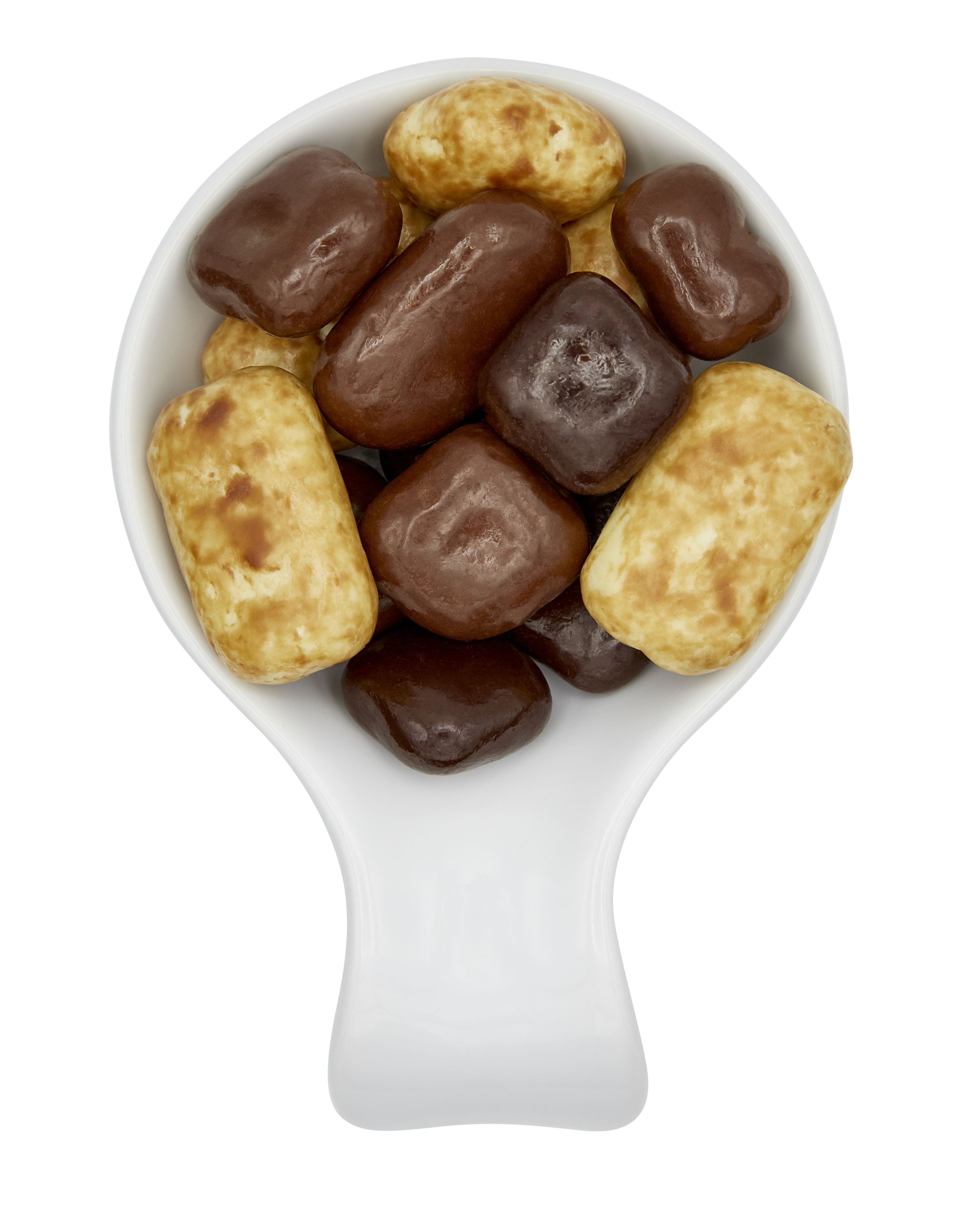 A white spoon filled with assorted chocolate-covered and caramel candies, isolated on a black background.