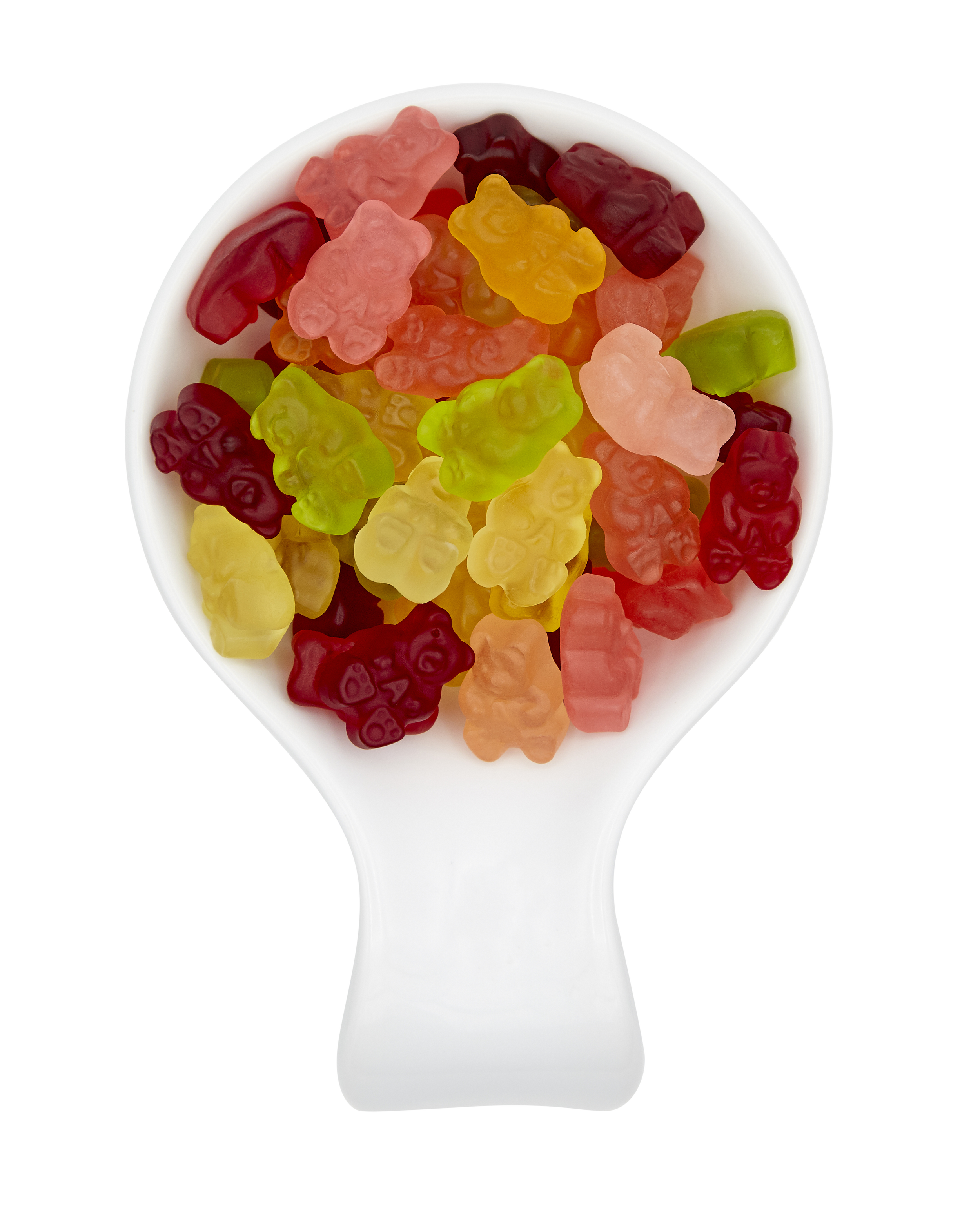 Gummy bears in a white scoop with a black background.