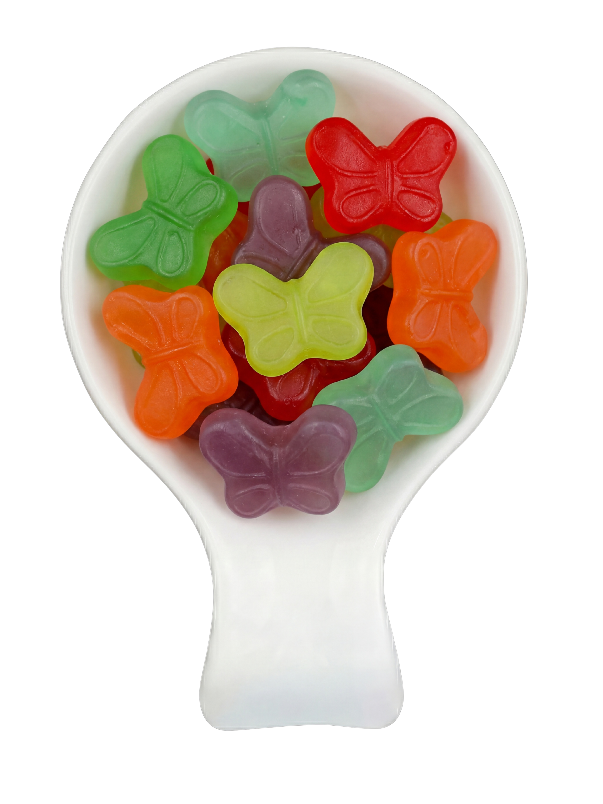 Colorful butterfly-shaped gummy candies in a white spoon against a black background.