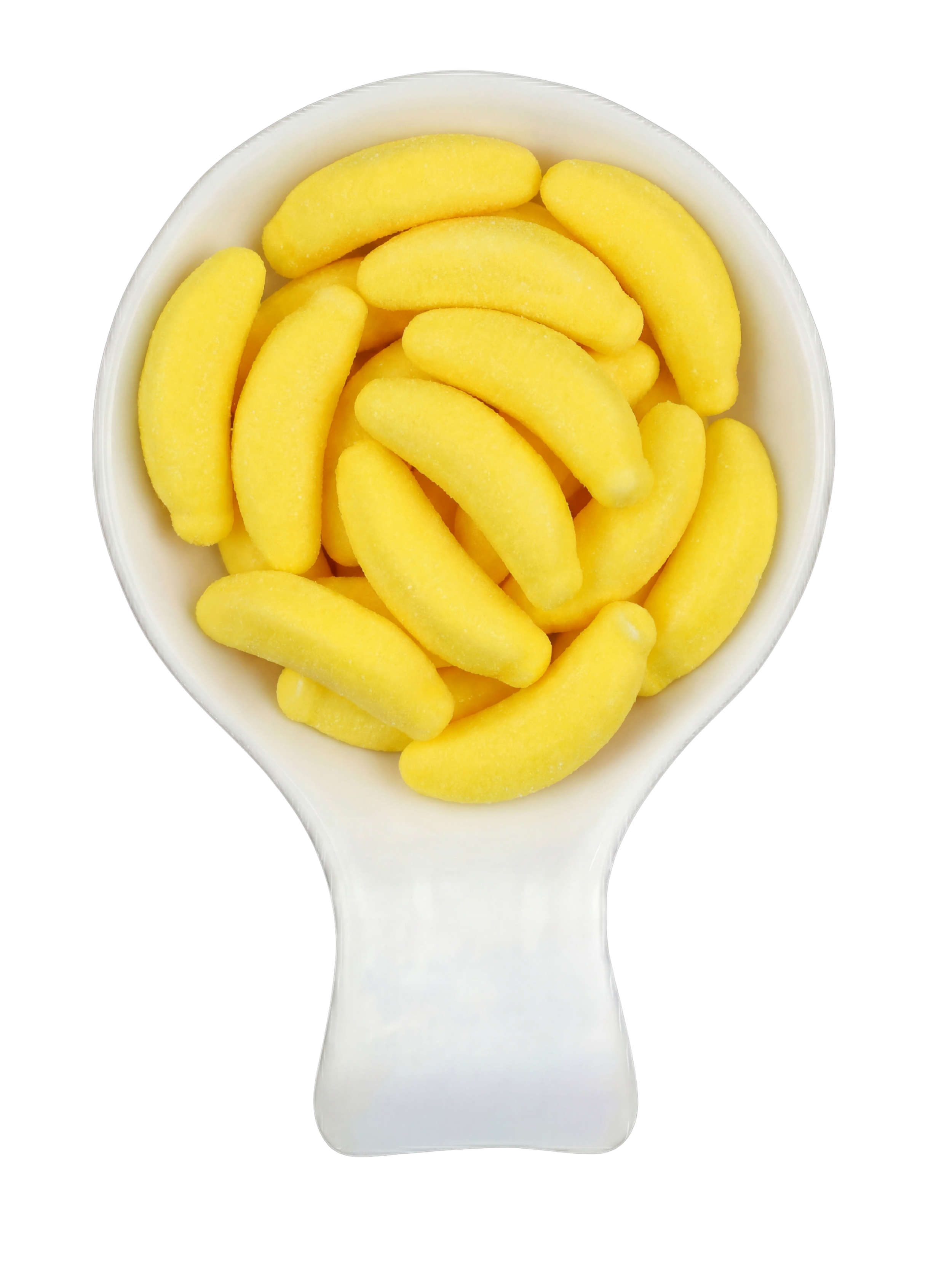 Close-up of a white spoon filled with yellow gummy banana candies against a black background.