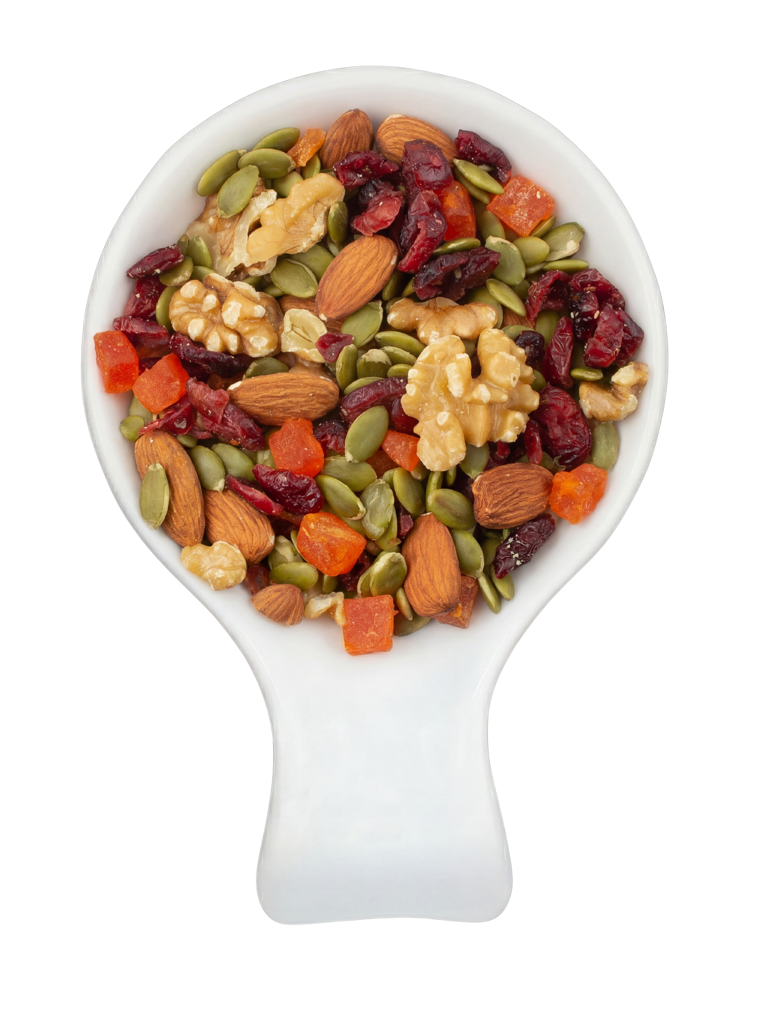 Close-up of a white ceramic spoon filled with assorted trail mix including almonds, walnuts, pumpkin seeds, dried cranberries, dried apricots, and other mixed nuts and dried fruits against a black background.