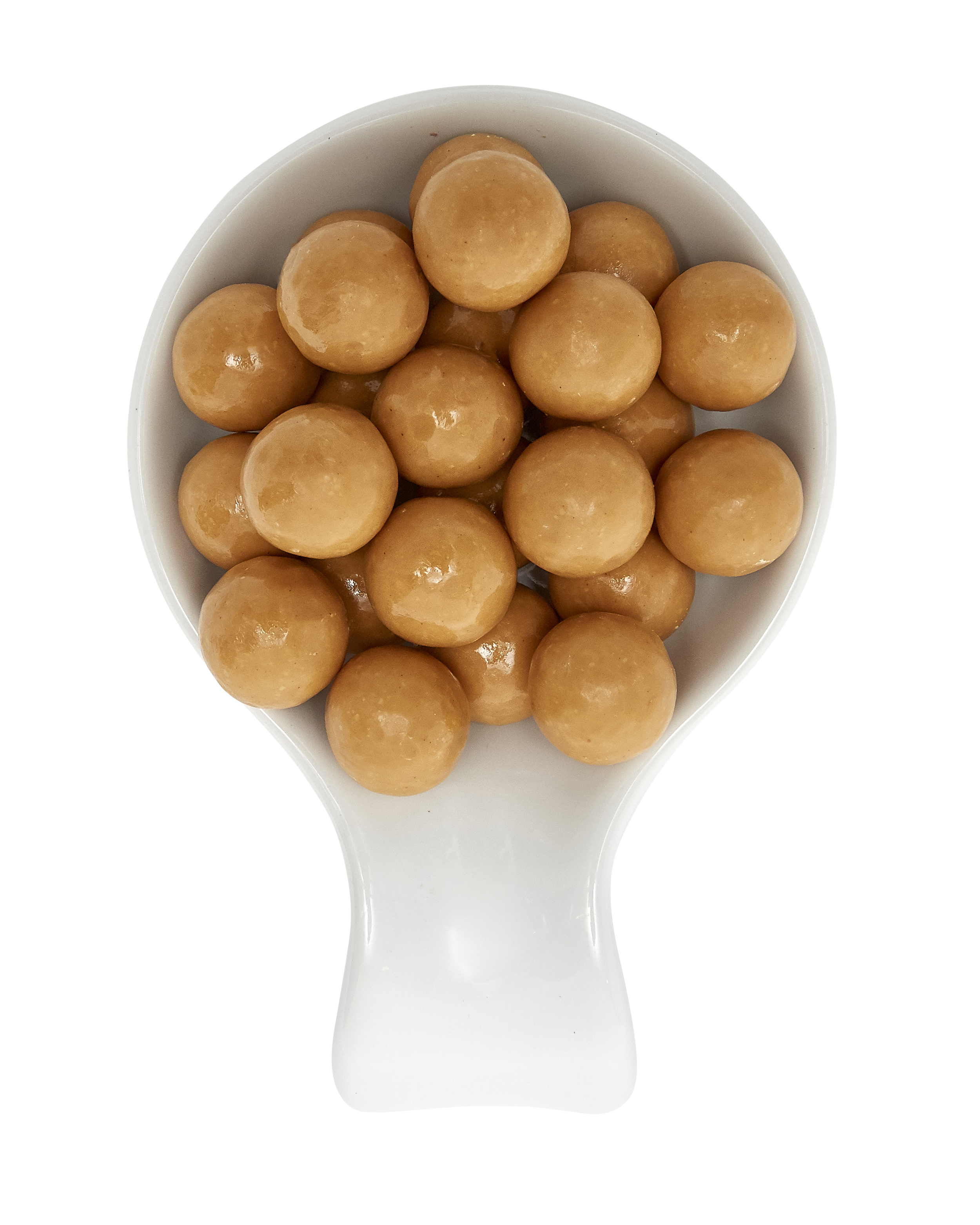 A white scooper filled with round, caramel-colored candies.