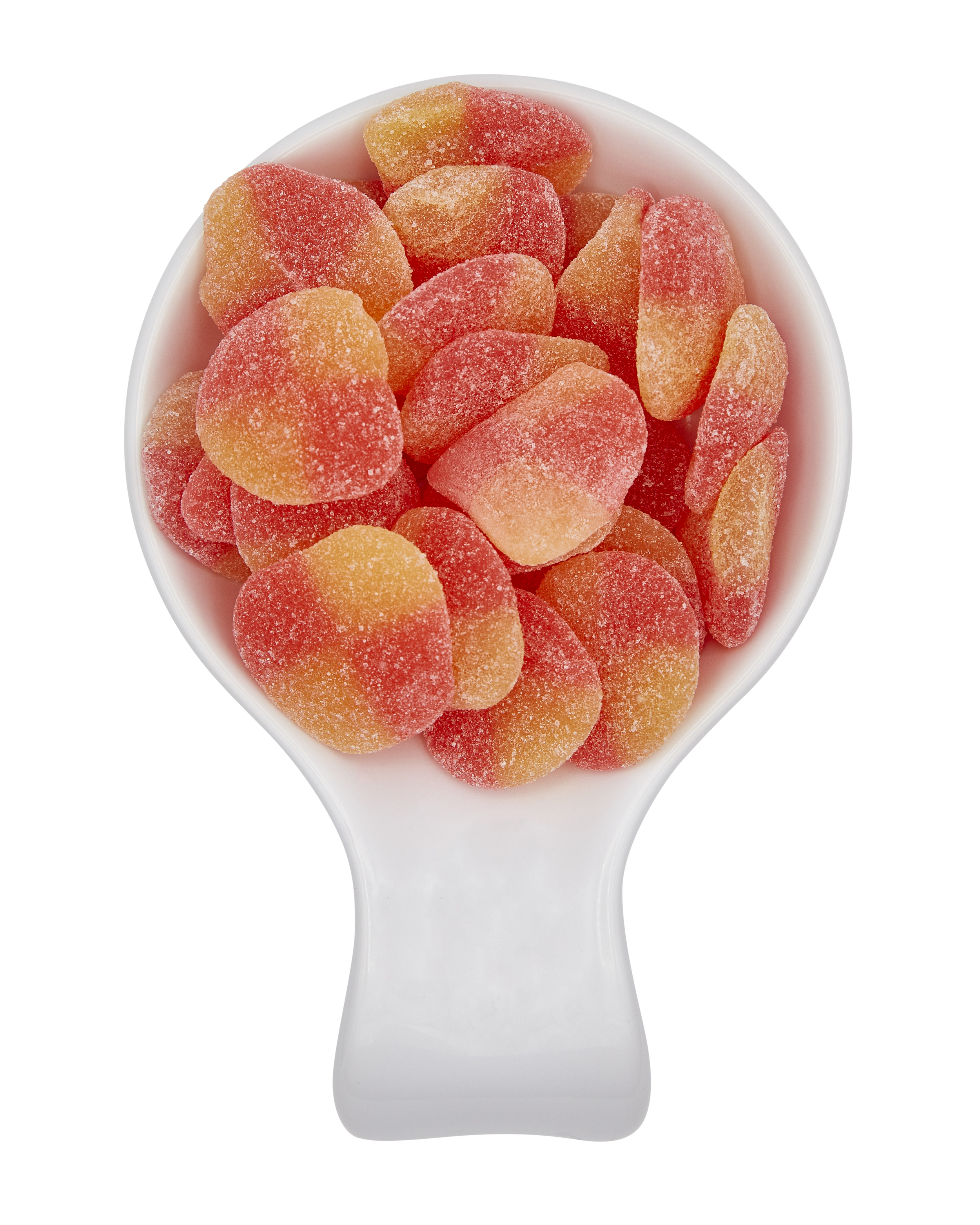 A white measuring scoop filled with sugared peach-flavored gummy candies.
