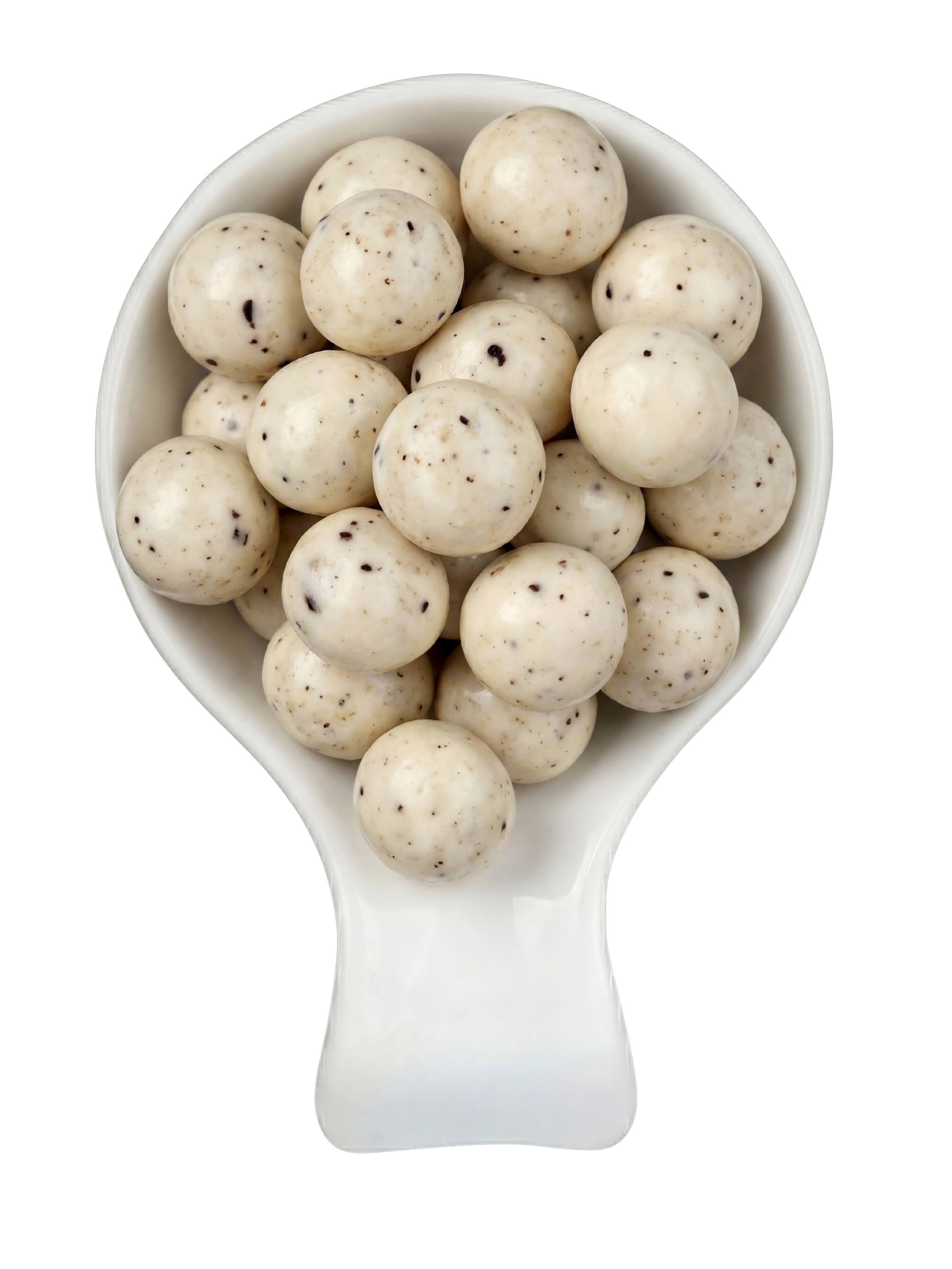 White bowl filled with speckled white chocolate candies on a white spoon against a black background.