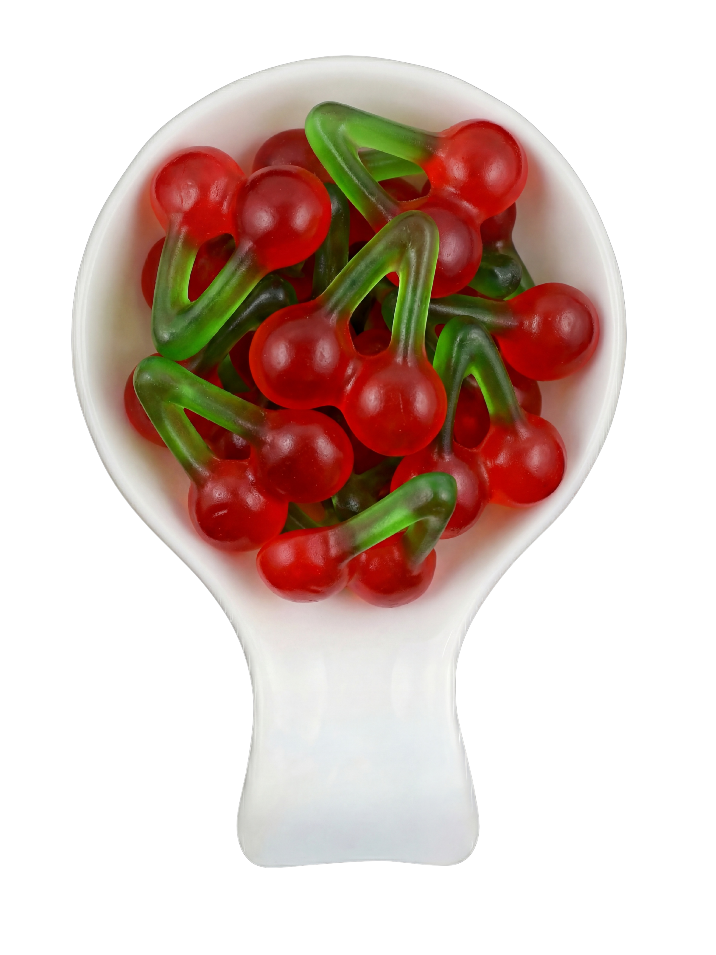 Red and green gummy candy shaped like cherries in a white spoon against a black background.