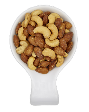 A white spoon filled with mixed nuts, including cashews and almonds.