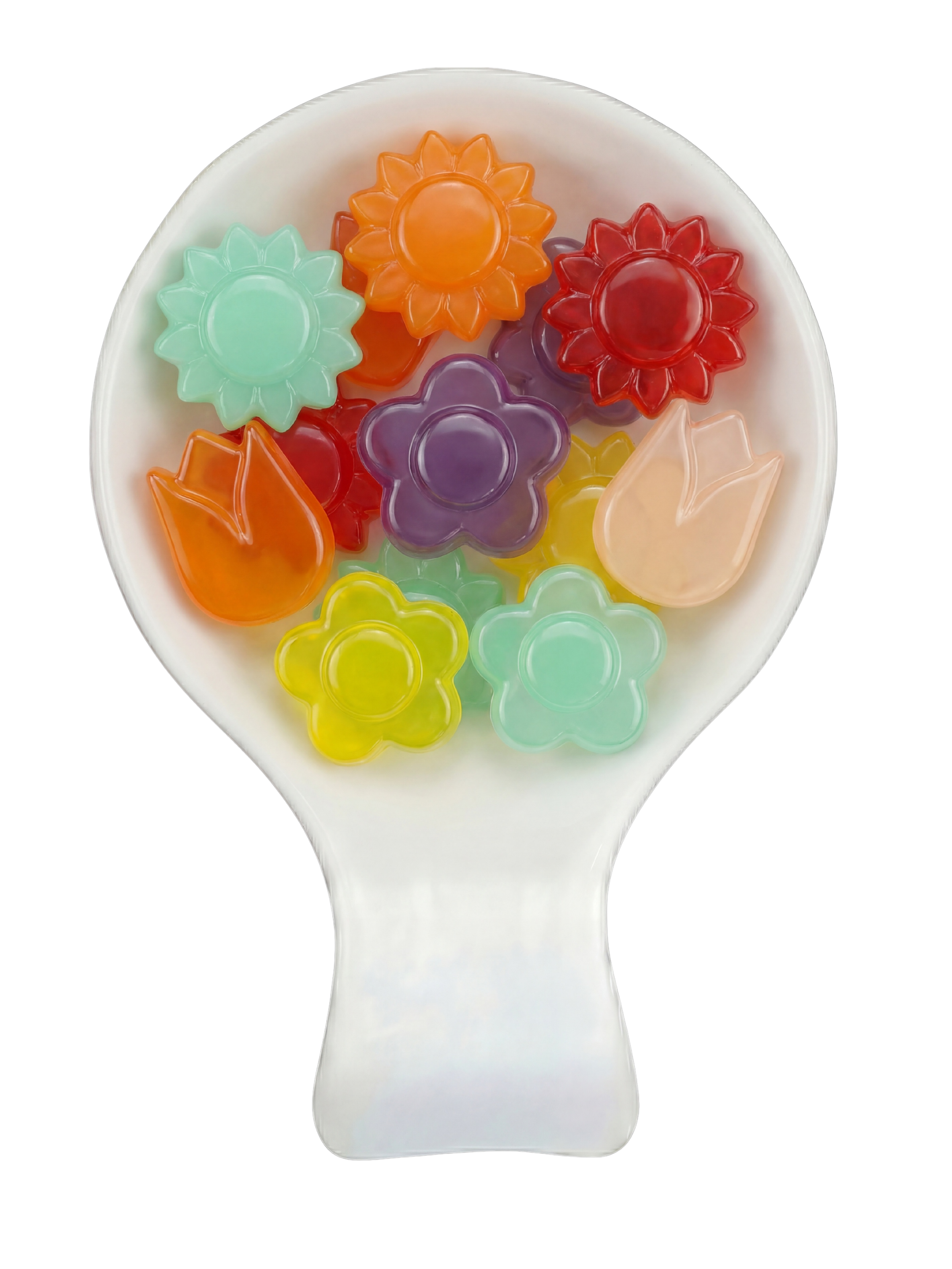 Close-up of a white spoon filled with colorful flower-shaped jelly candies in orange, purple, red, yellow, green, and pink, set against a black background.