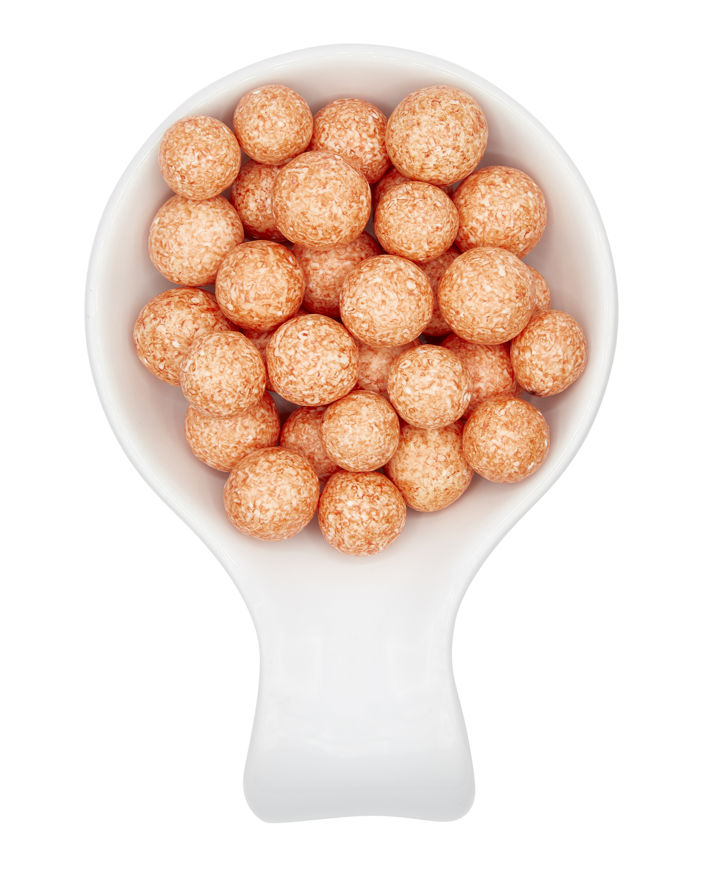 White scoop filled with round, orange-colored textured snack balls on a black background.