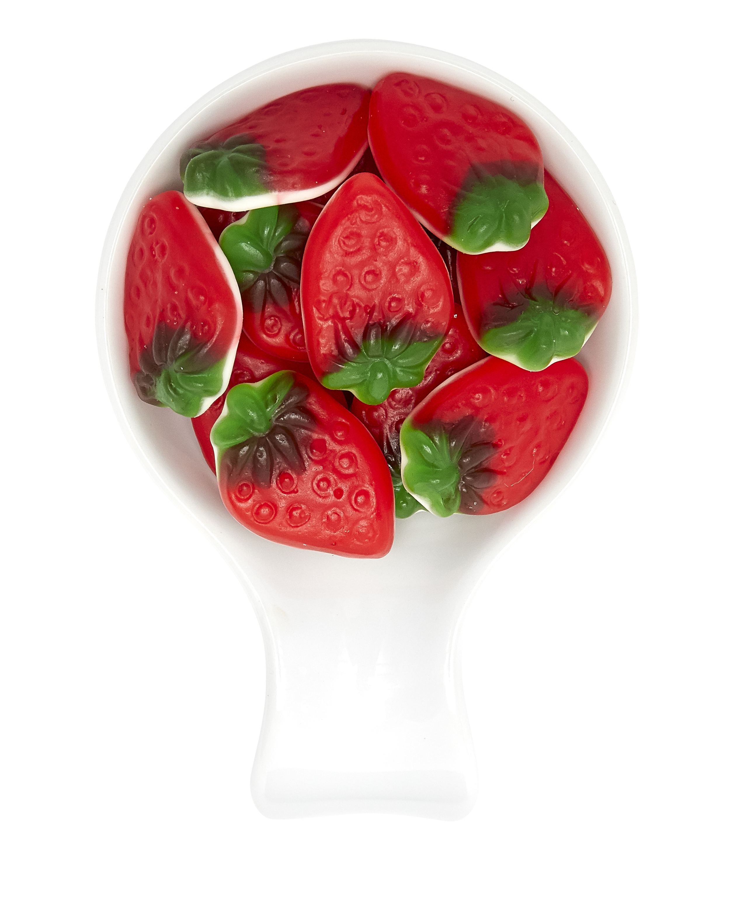 A white scoop filled with red and green gummy strawberries on a black and white background.