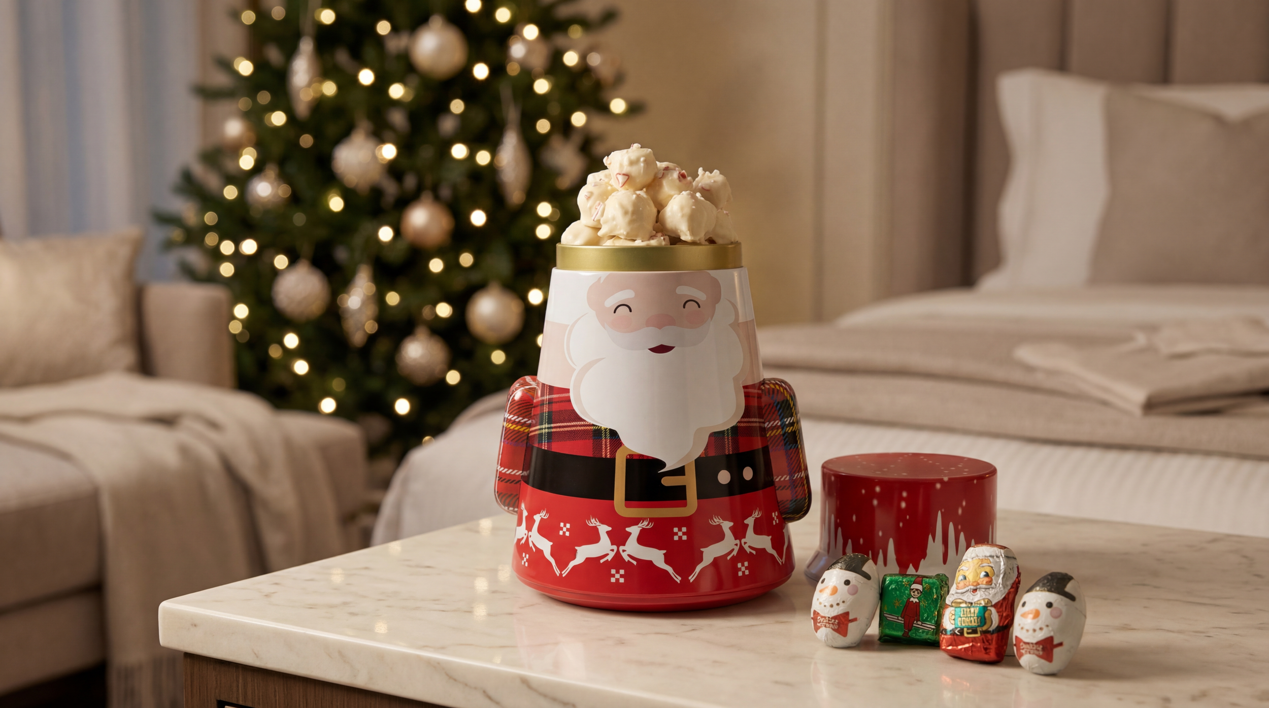 A santa popcorn filled tin in a Christmas setting.