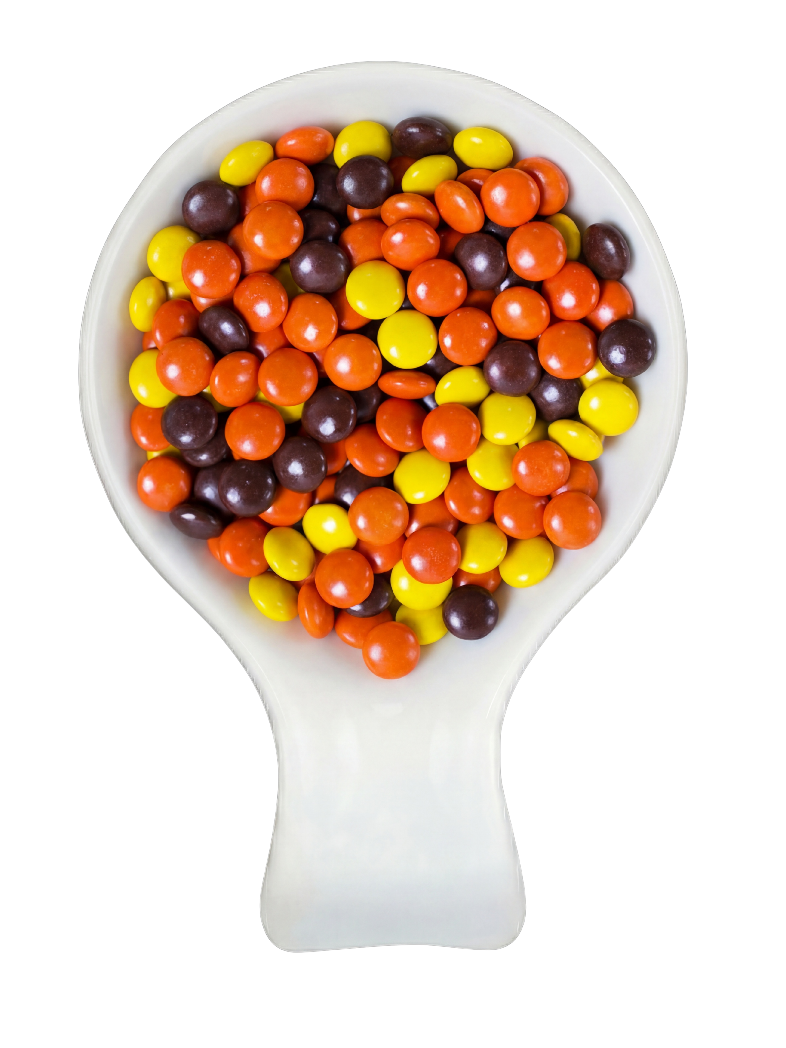 A white spoon filled with colorful round candies including yellow, orange, and dark purple candies, set against a black background.