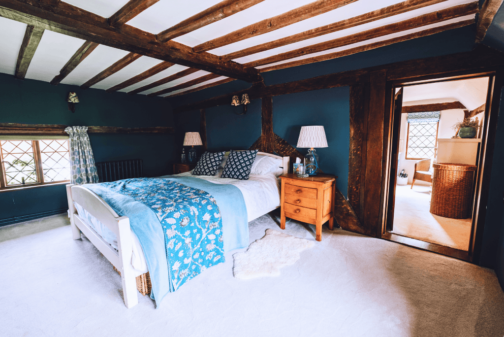 Rustic bedroom with exposed beams at High Birch.