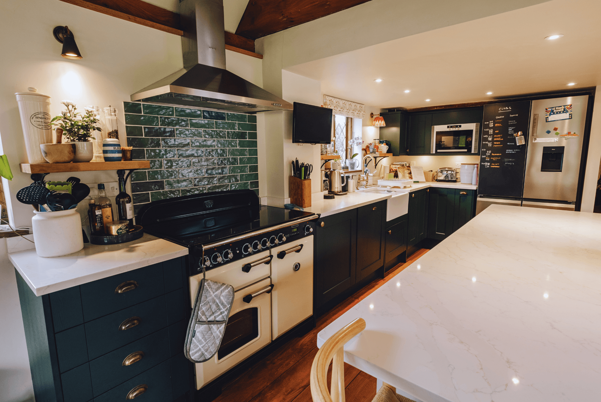 Character kitchen with green tiles and farmhouse style interiors.