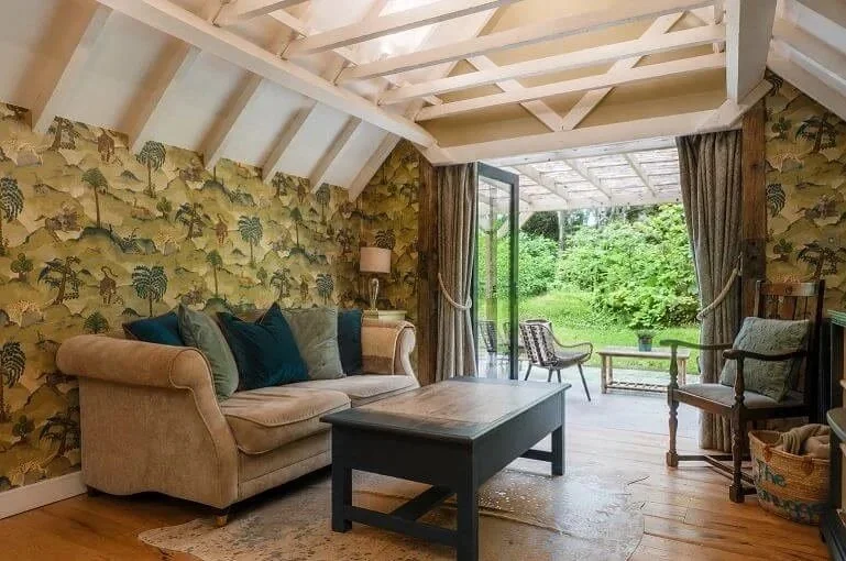 Bright and cosy living room at The Snuggery with woodland views and direct access to the surrounding Kent countryside.