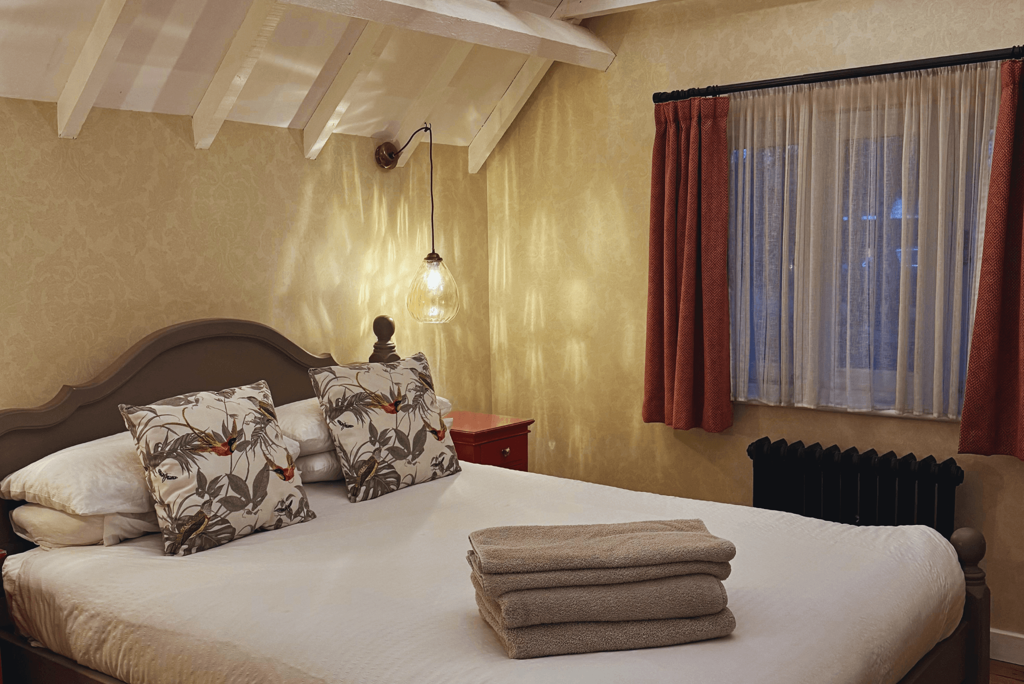 Rustic bedroom with exposed beams at The Snuggery.