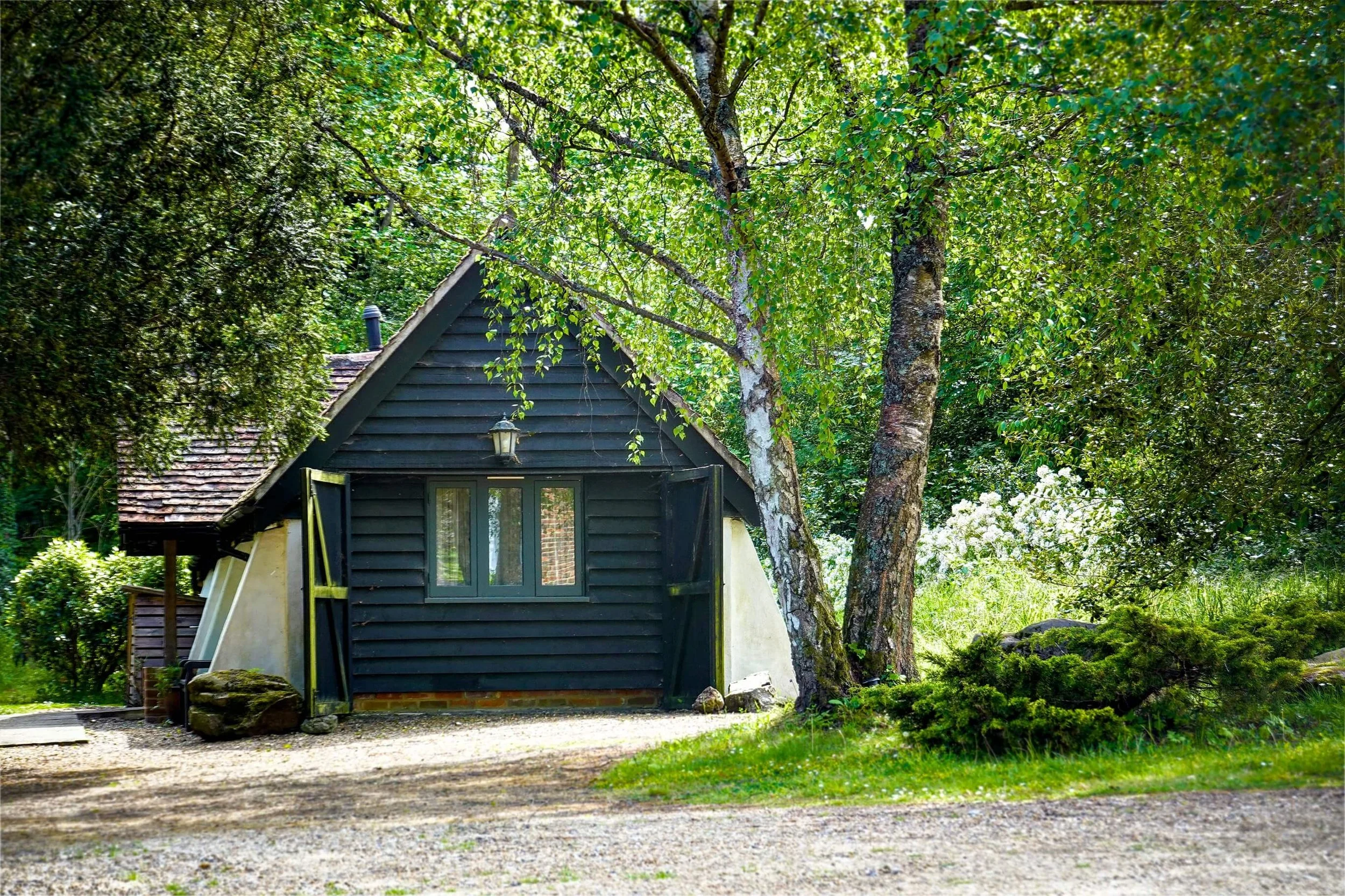 The Snuggery surrounded by woodland in the Kent countryside.