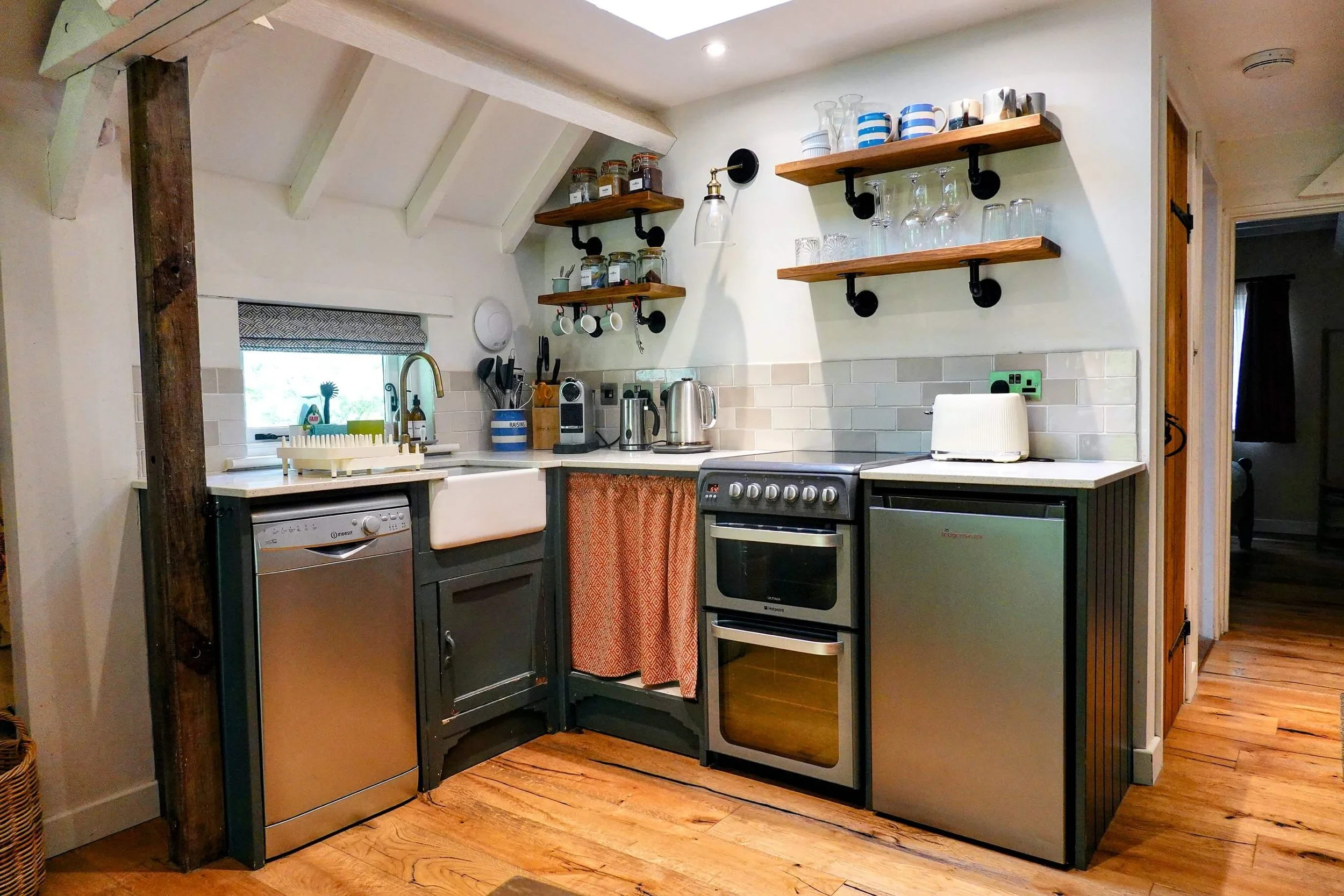 Well-equipped kitchen at The Snuggery featuring open shelving, modern appliances and everything needed for a comfortable self-catering stay.