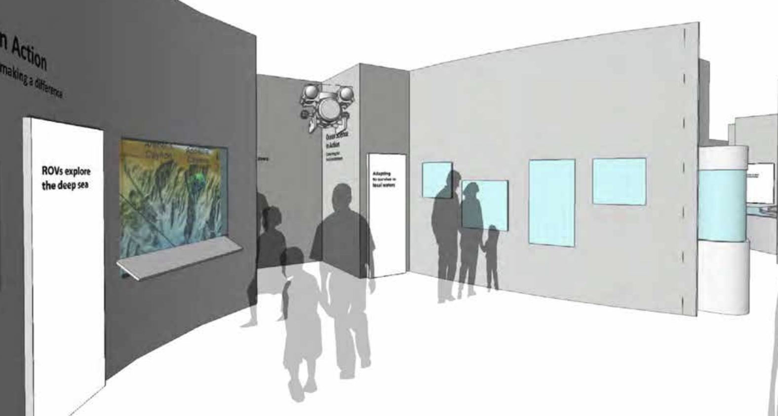 Museum exhibit with displays about exploring the deep sea, including an interactive screen, framed artwork, and visitors observing the exhibits.