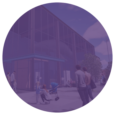 People walking and sitting outside a modern glass-front building with trees and streetlights.