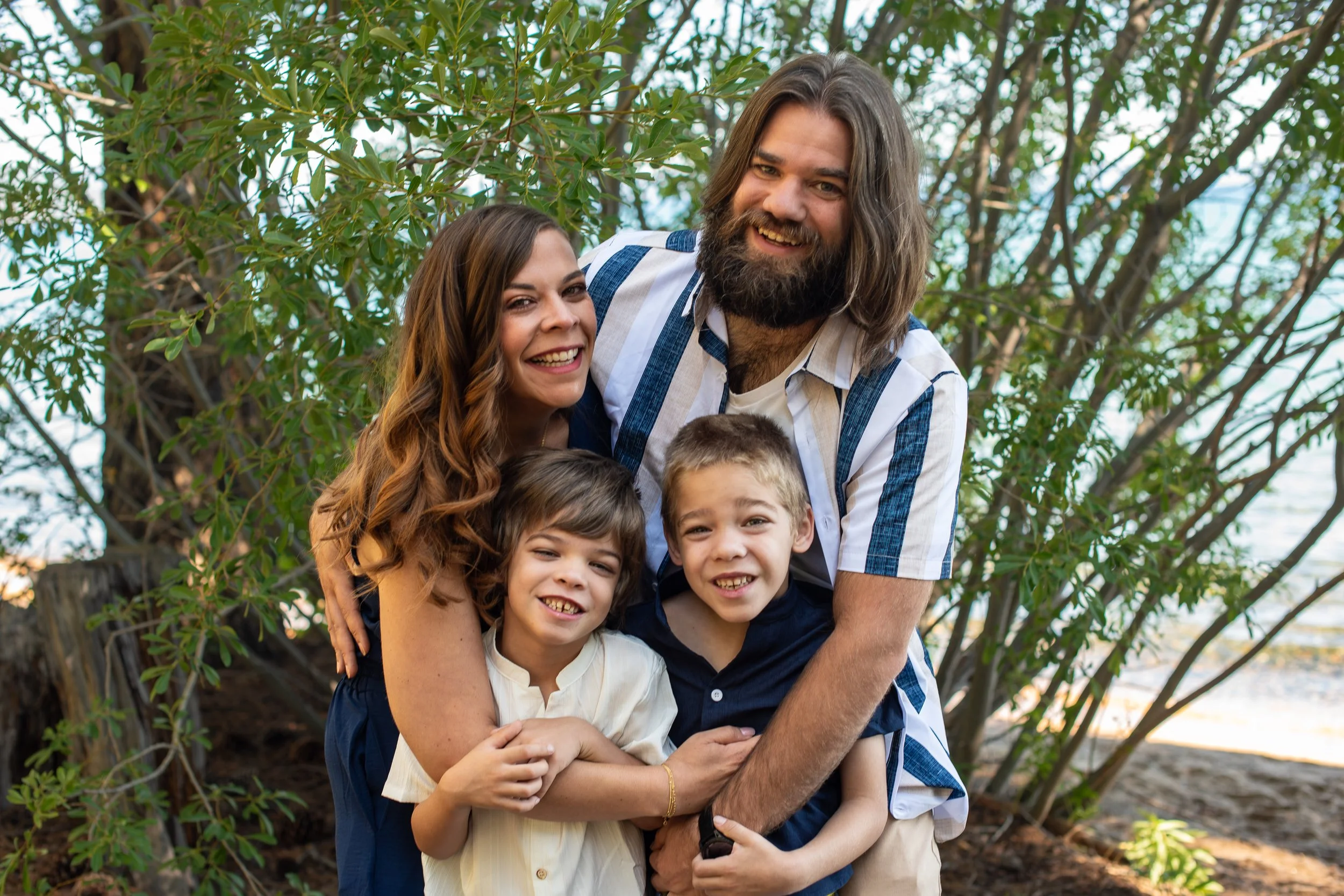 Family of four coordinating outfits in blue and cream