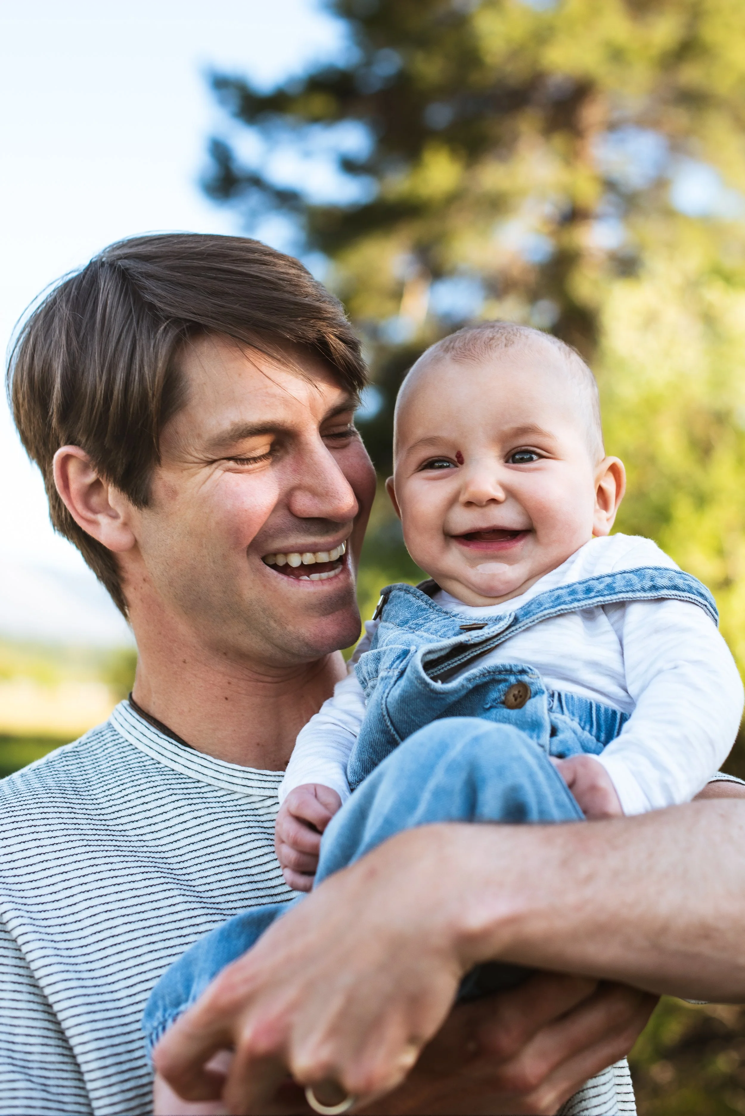 Family photo of father and son laughing