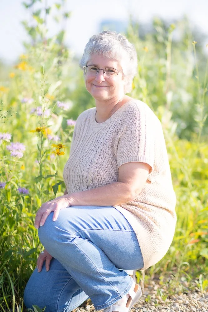 Photo of a lady by some wild flowers in a field at Pope Farm Conservancy, Madison WI