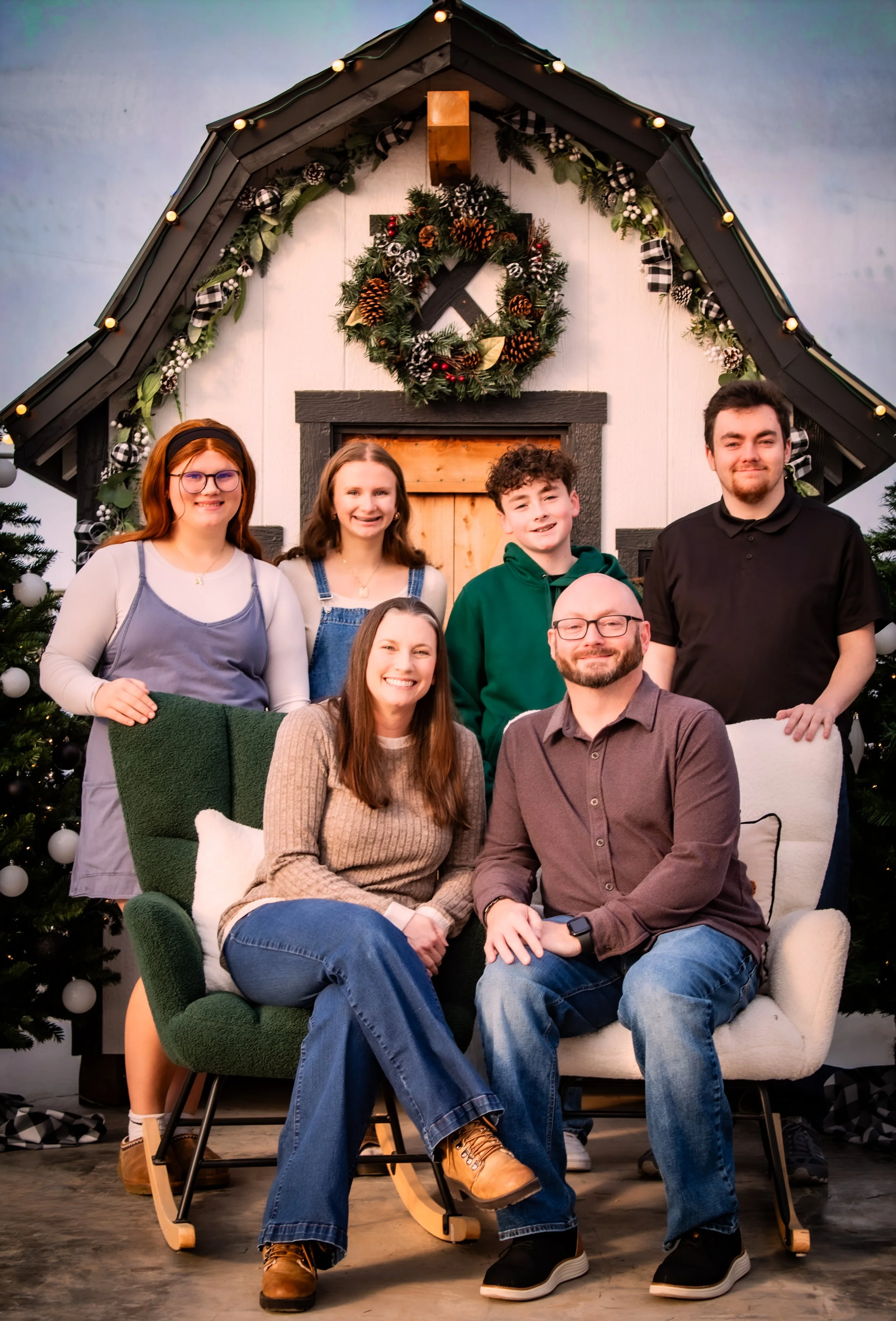 Family Christmas photos at an evergreen tree location near Sun Prairie Wisconsin.