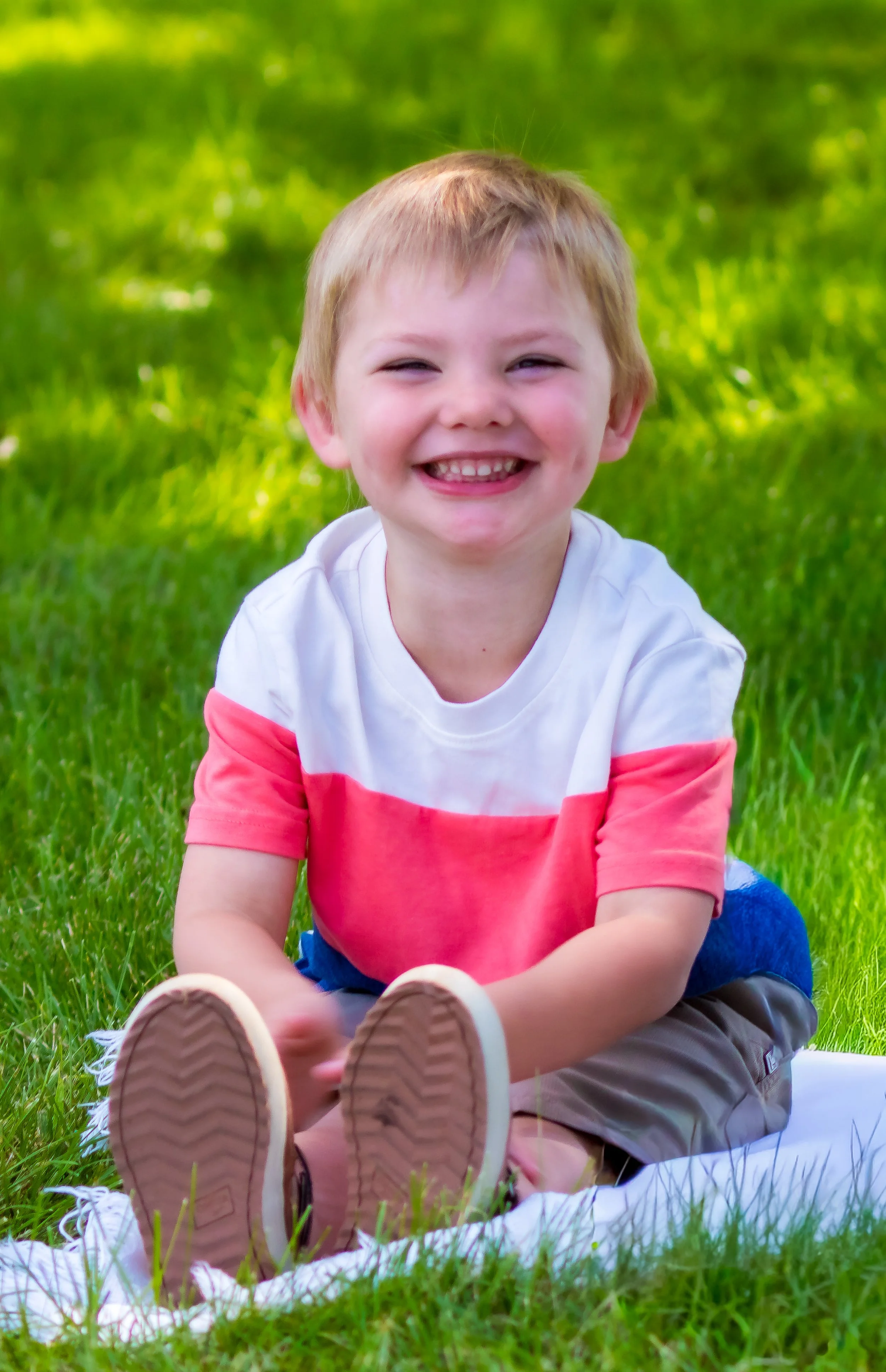 Little boy posing for outside photo for school day smiles