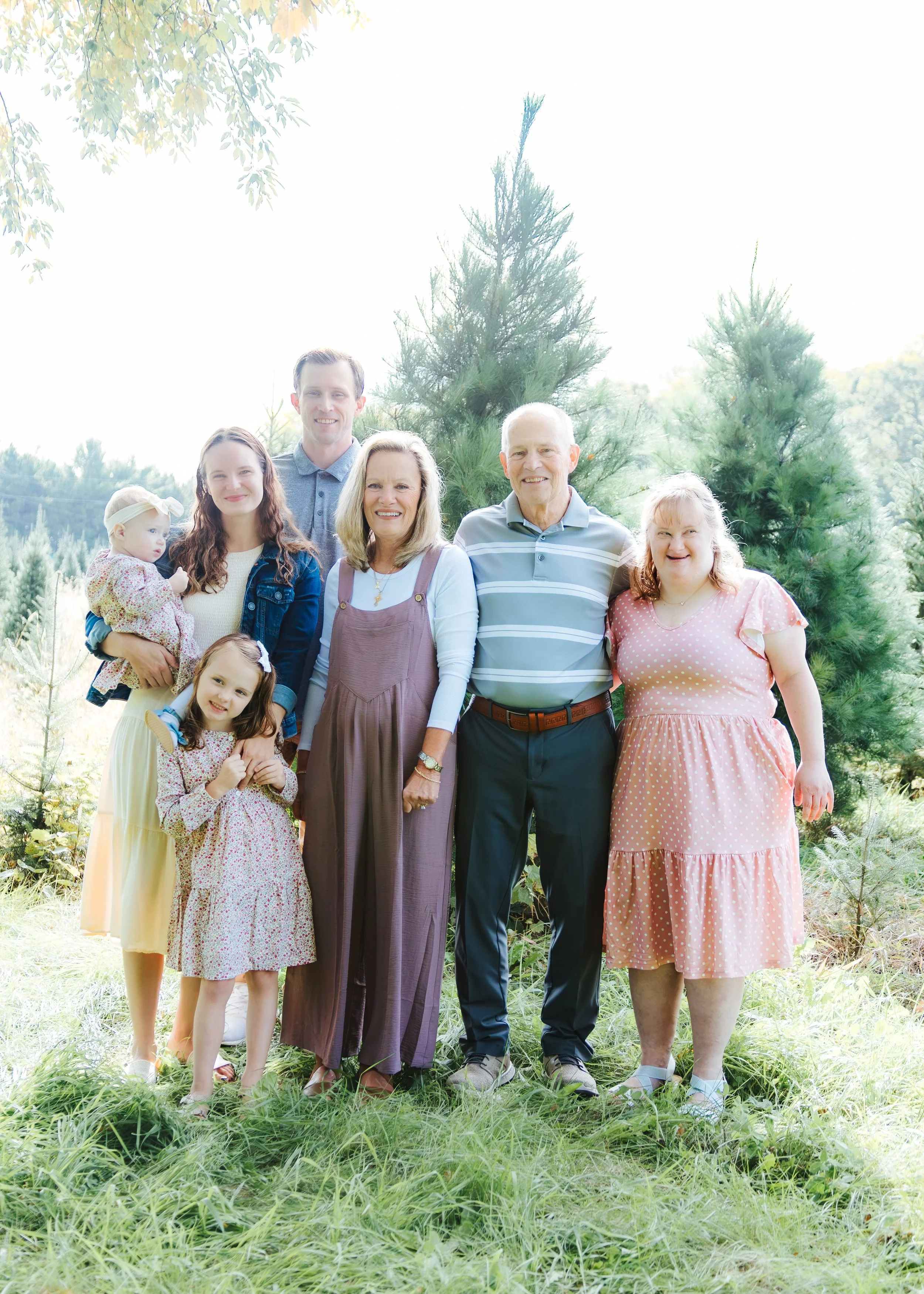 Family Christmas photos at an evergreen tree location near Sun Prairie Wisconsin.