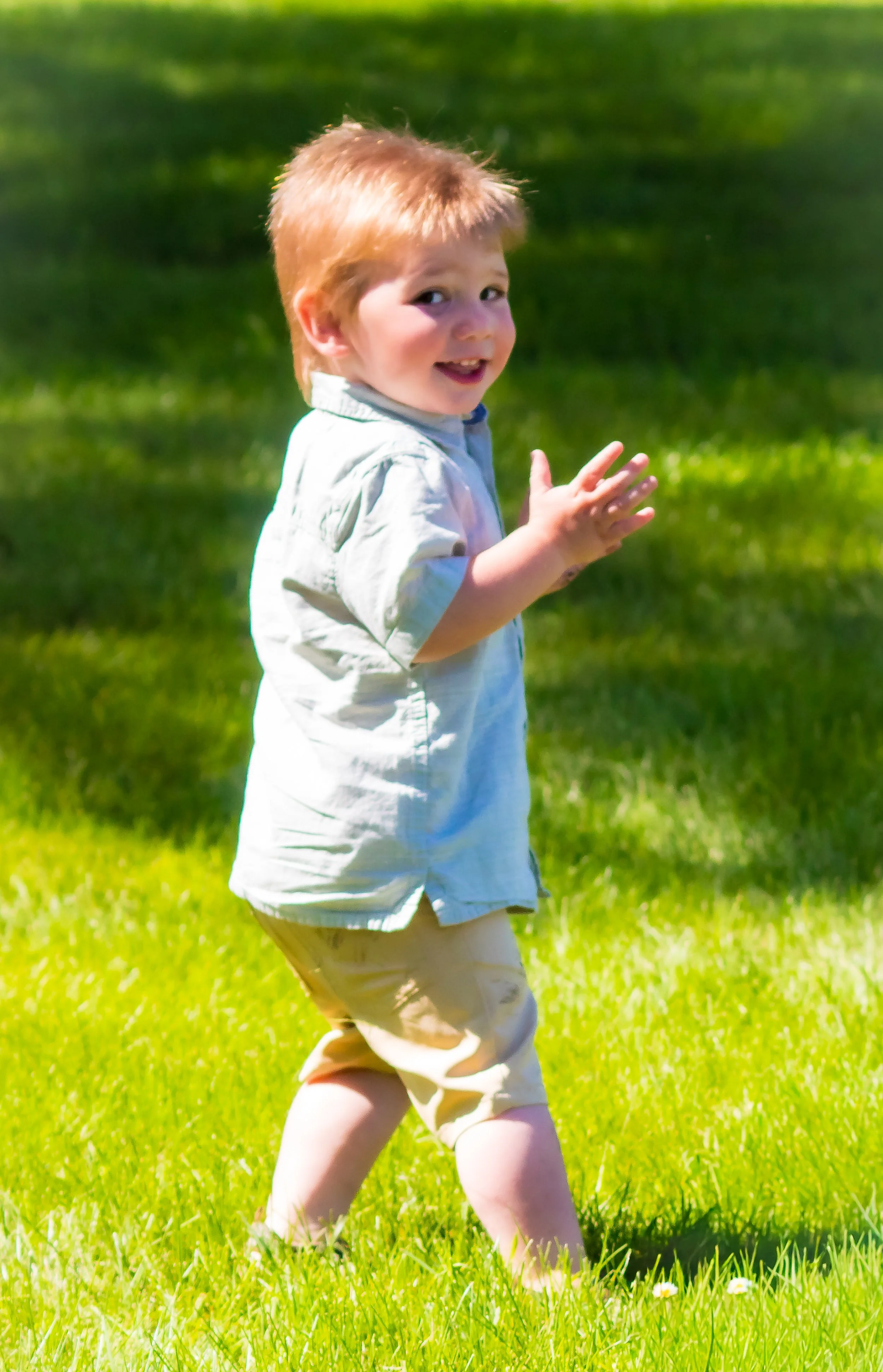 Little boy running and turned to smile for camera