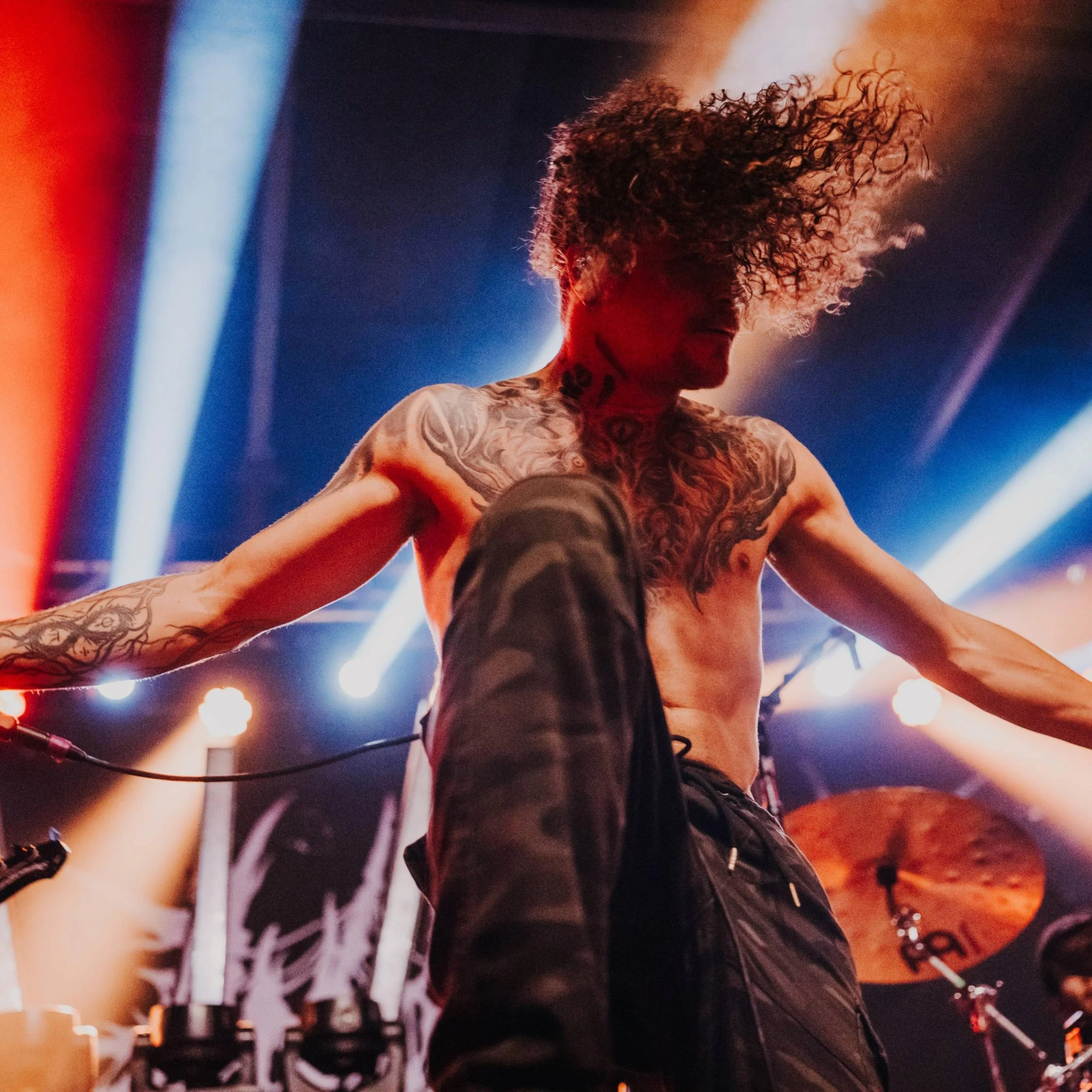 Casey on stage with his arms spread and his arms outstretched