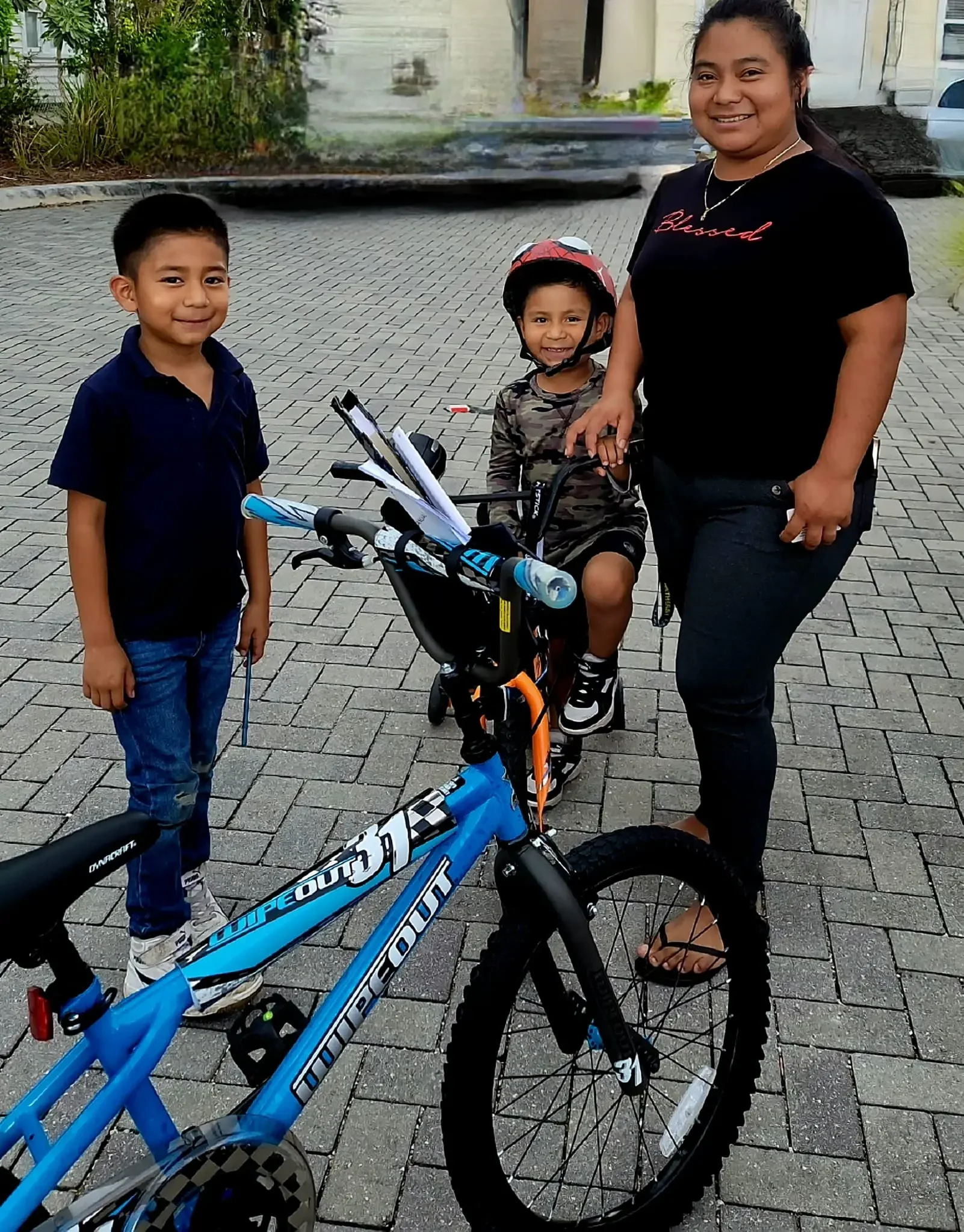 2 boys with new bicycles and mom