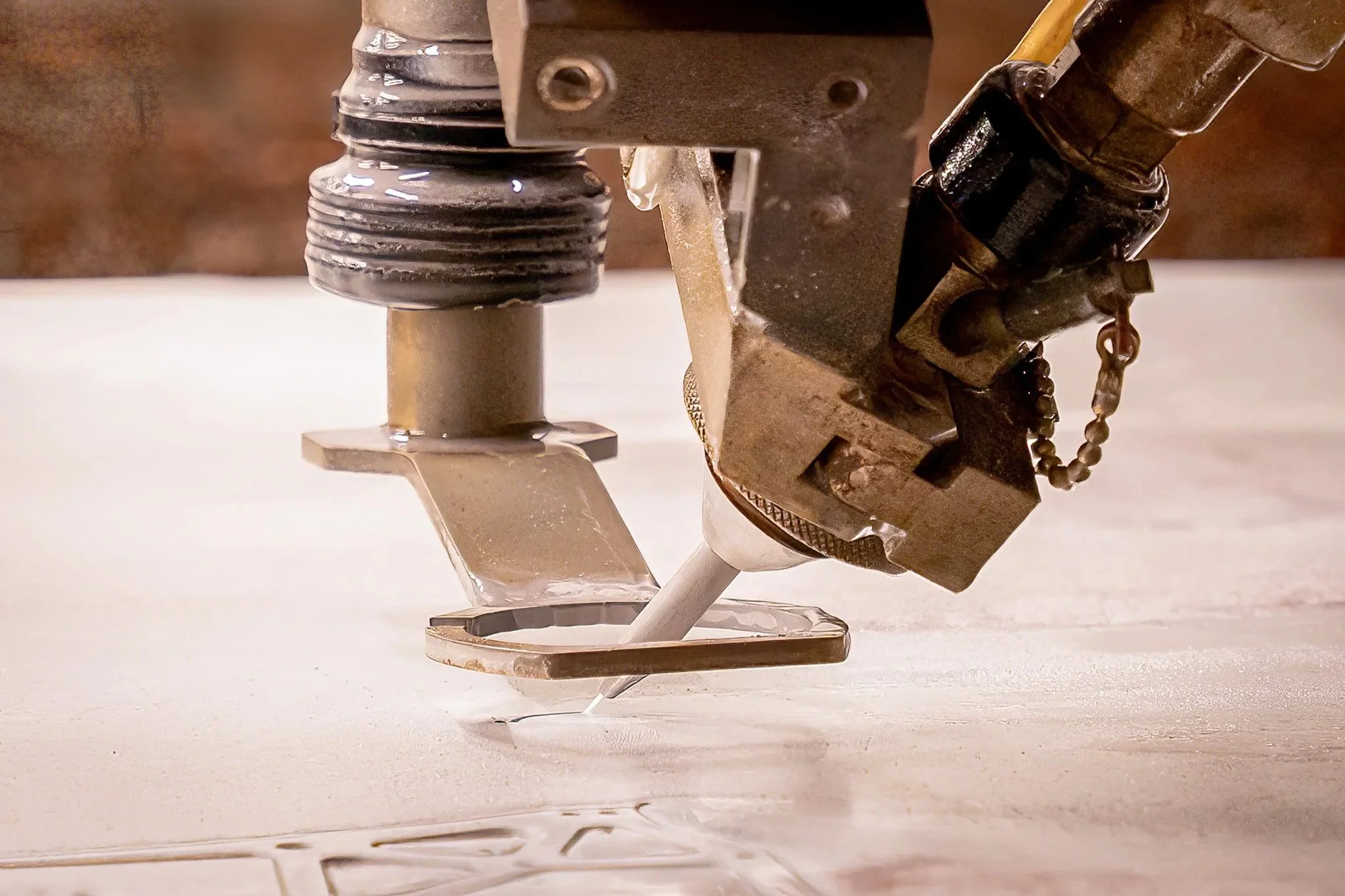 Close-up of a robotic or automated tool cutting or engraving into a surface.