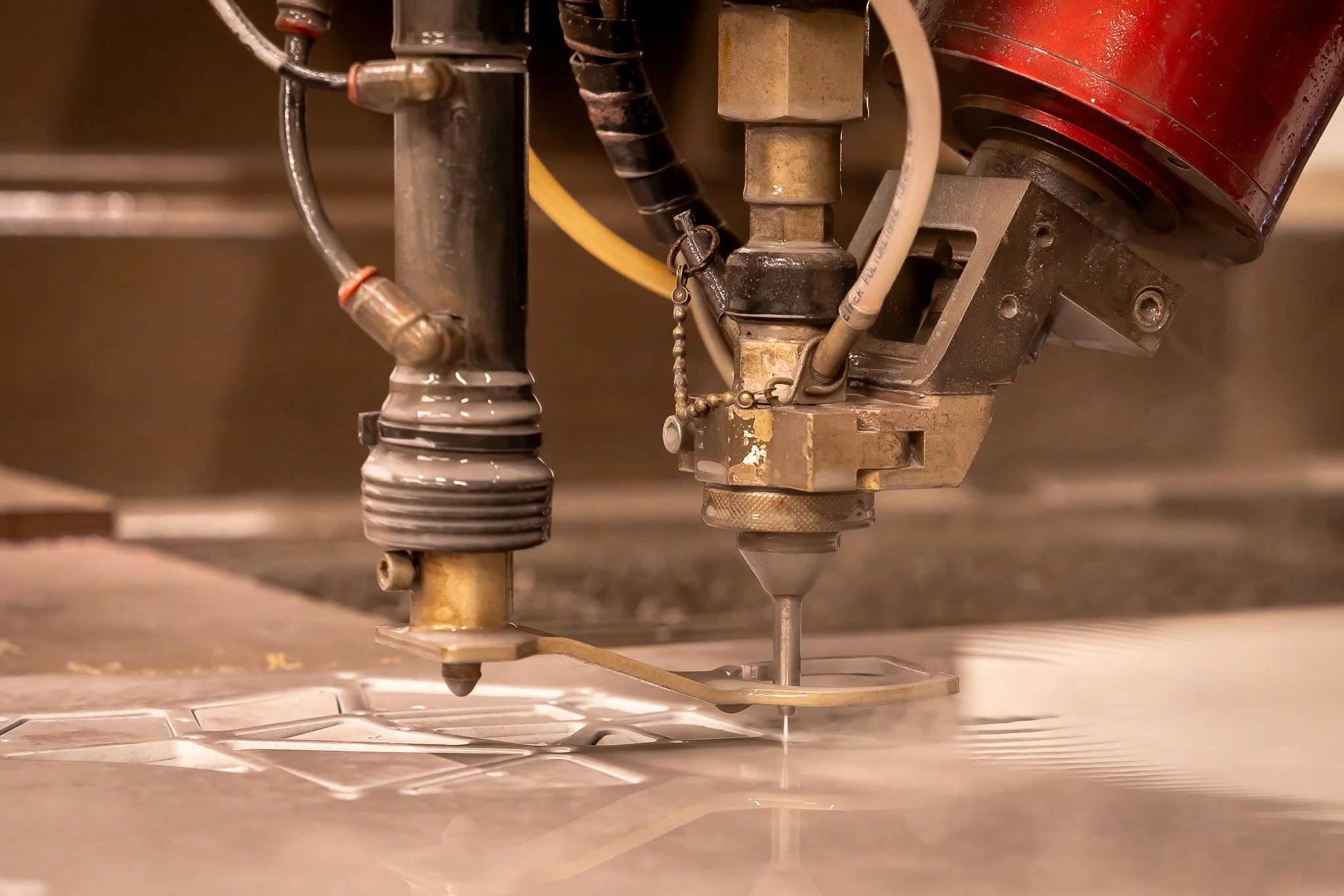 Close-up of a CNC machine cutting metal with a precision drill bit, sparks flying, on a metallic surface.
