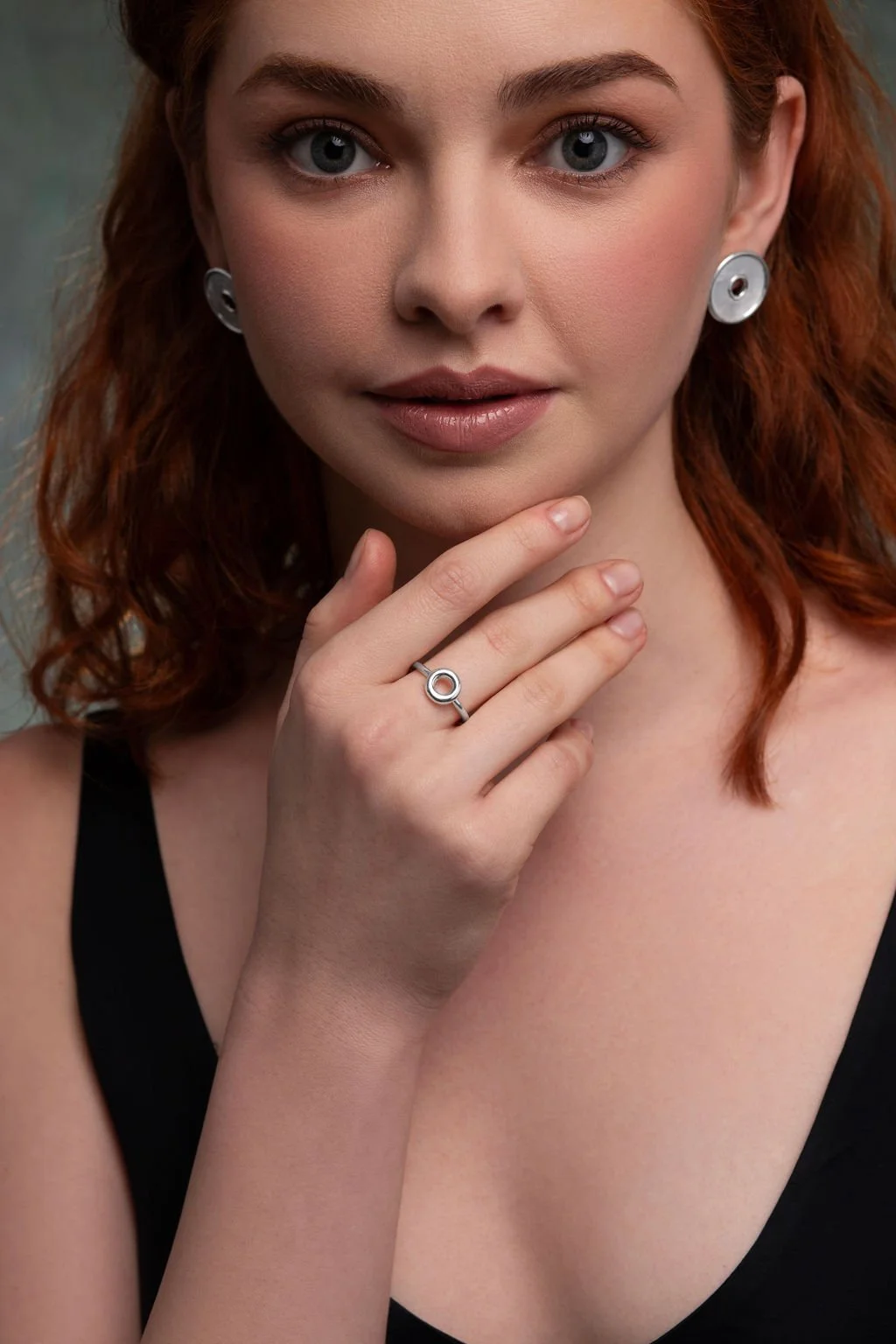 Hand wearing sterling silver Monad ring, torus form creating a focal point on the finger