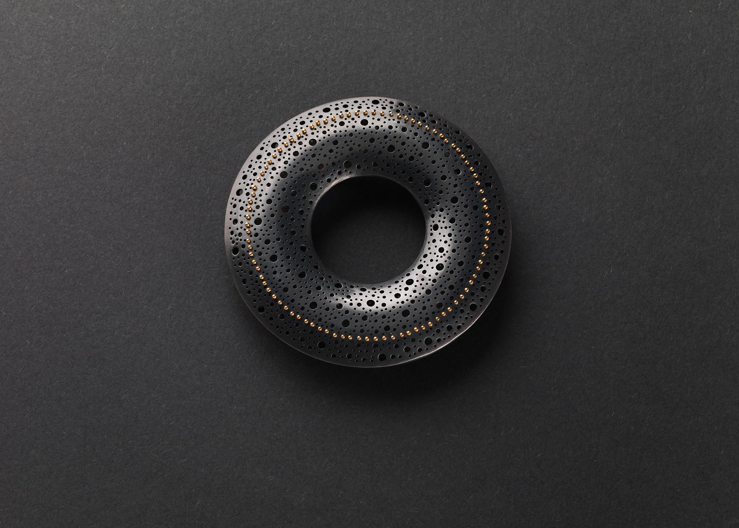 Sum in Black Brooch in oxidised sterling silver with hand-pierced surface and 22ct gold rivet detail
