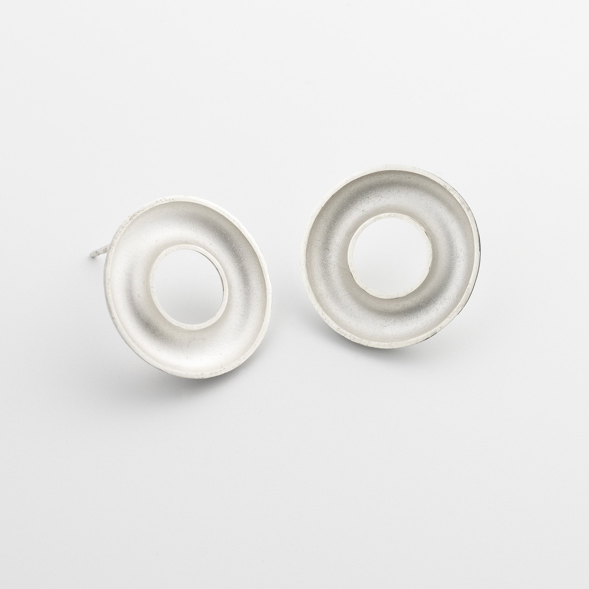 Sterling silver Orbis medium stud earrings, circular, concave torus form, polished edge and white interior