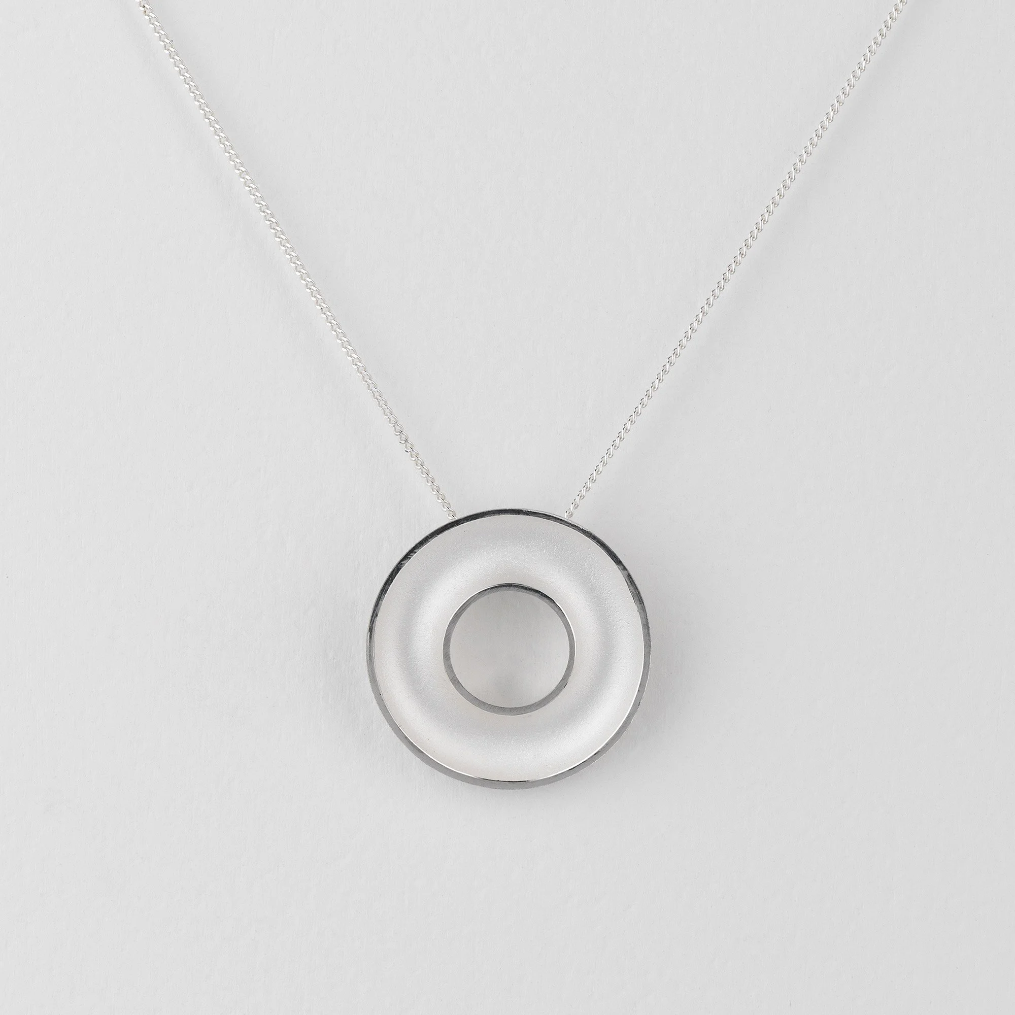 Sterling silver Orbis medium necklace, circular, concave torus pendant, polished edge and white interior