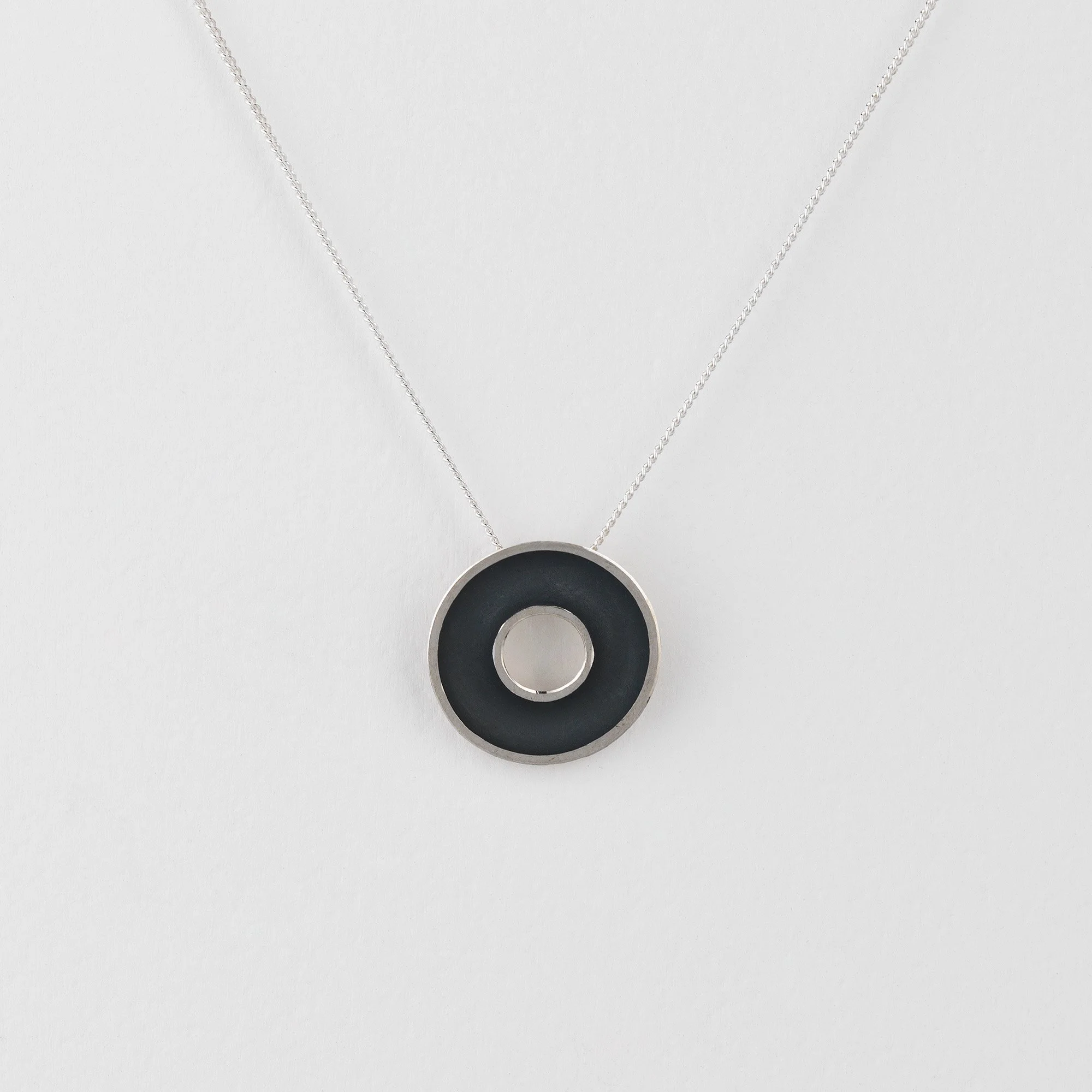 Sterling silver Orbis small necklace, circular, concave torus pendant, polished edge and oxidised interior
