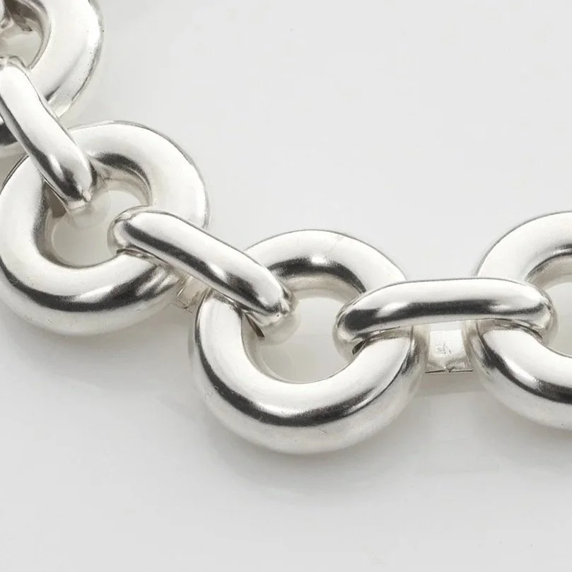 Close-up of Monad Link bracelet showing thick hand-drawn wire torus links