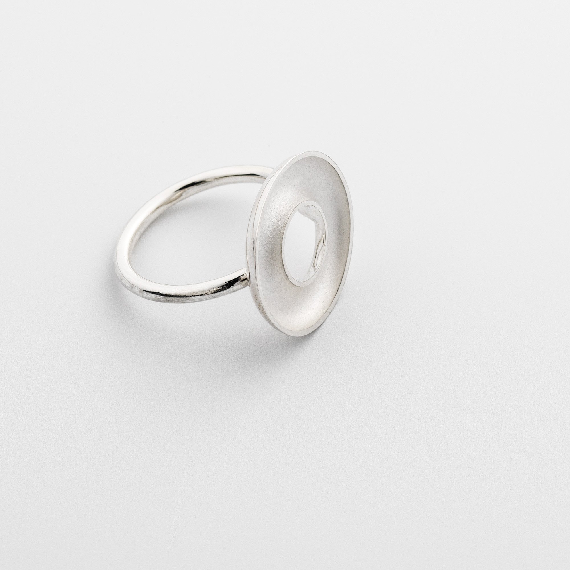 Sterling silver Orbis medium ring, concave torus form, polished edge and white interior on round band