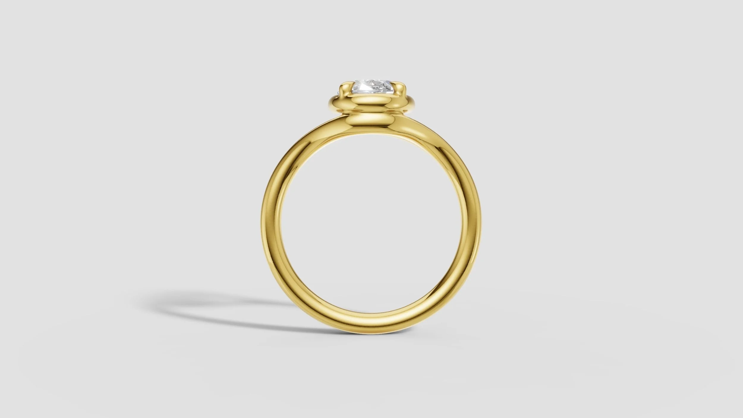 Profile view of 18ct gold ring with 2ct oval diamond in raised torus style setting.