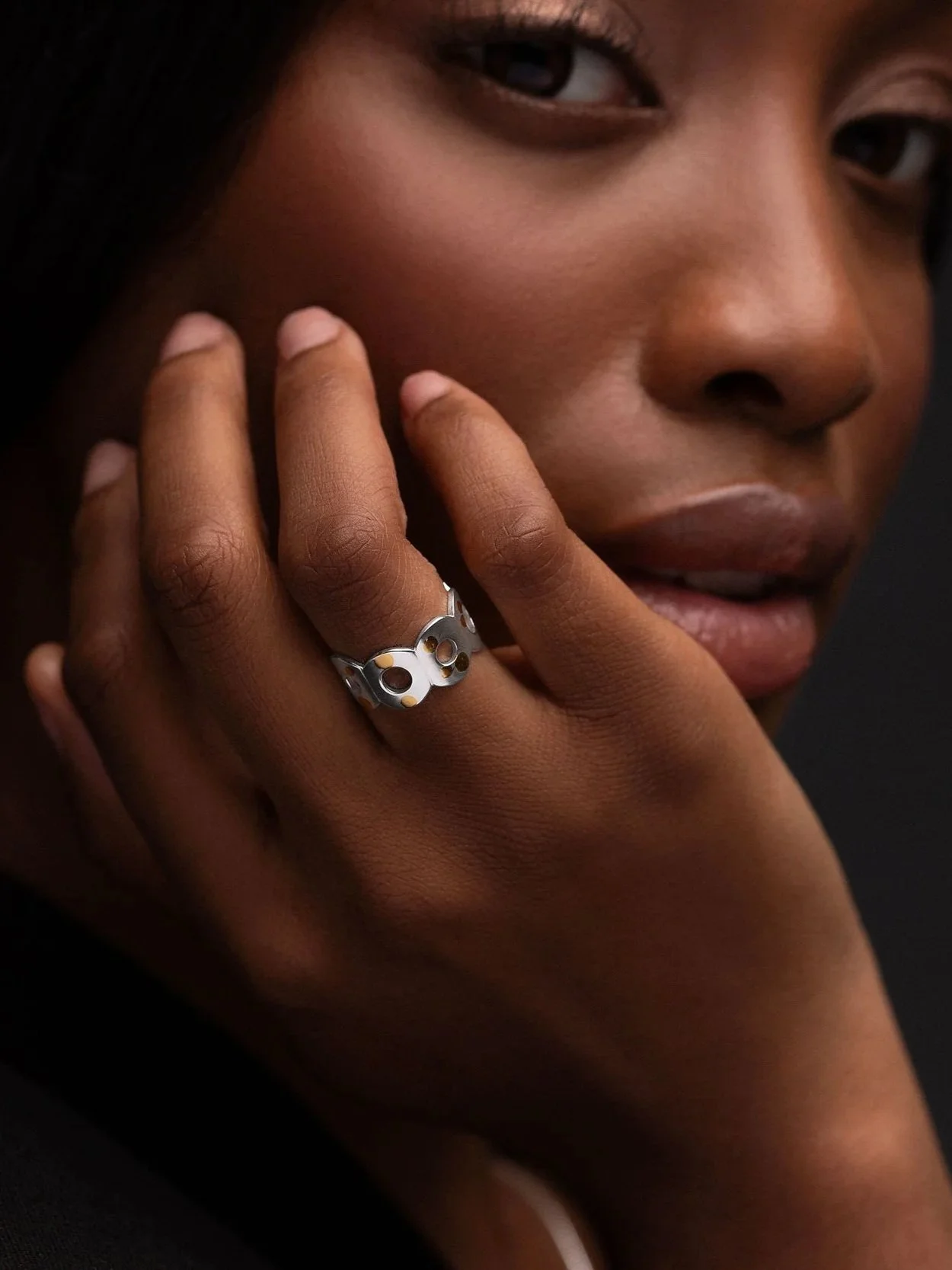 Hand wearing sterling silver Kairoi open ring, torus form across the finger