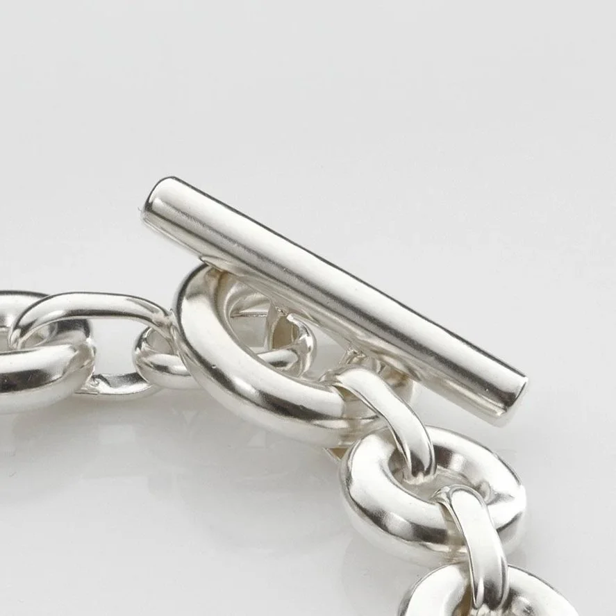 Close-up of Monad Link bracelet showing thick hand-drawn wire torus links and T-bar clasp